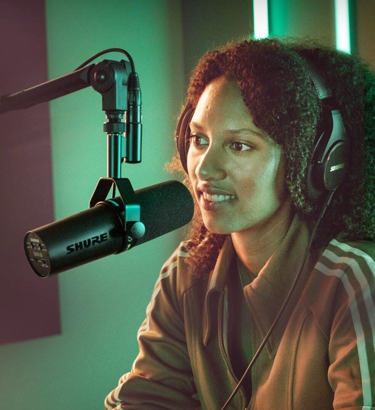 Woman recording a podcast in home studio