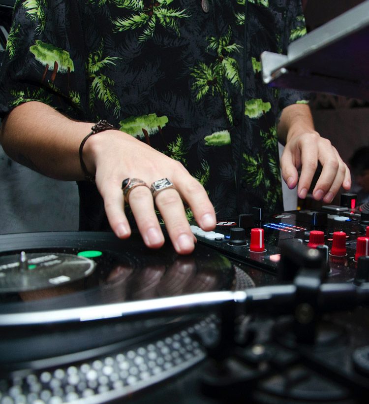 Close-up of person's hands spinning a record on a turntable