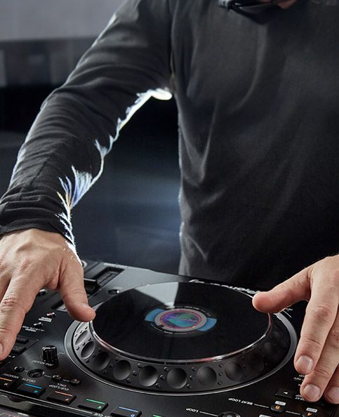 Woman cueing up song on Pioneer CDJ