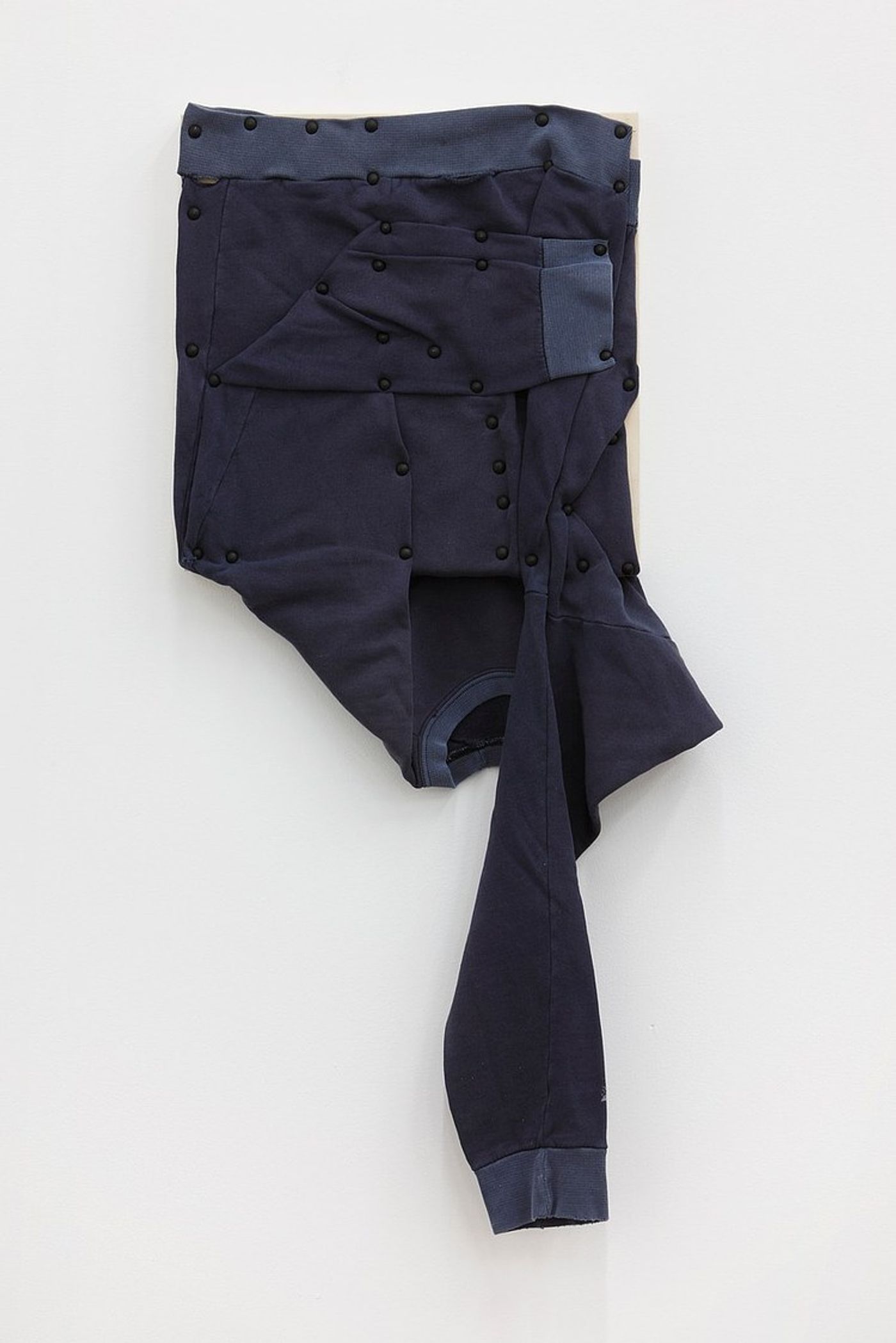 Tom Burr, his personal effects (long sleeve, blue), 2012. Men's sweatshirt, upholstery tacks and plywood, 37 x 15 in (94 x 38.1 cm).