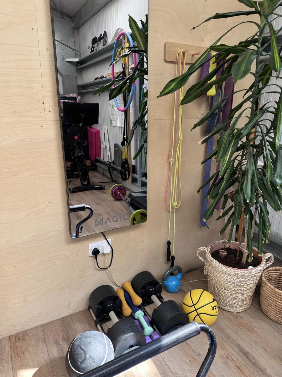 The Magic Mirror training screen in the shed at Bothan Jura Retreat, Isle of Jura, with kettlebells, dumbbells and a medicine ball