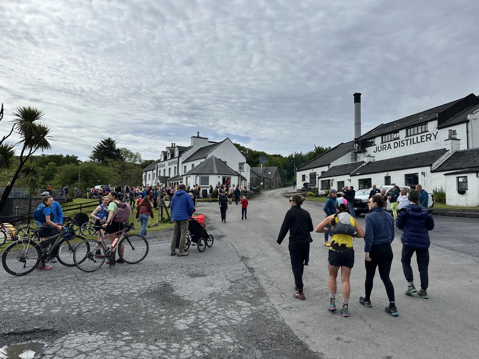Jura Distillery and the Jura Hotel in Craighouse on Fell Race morning, with runners, bikes and the village out on the road