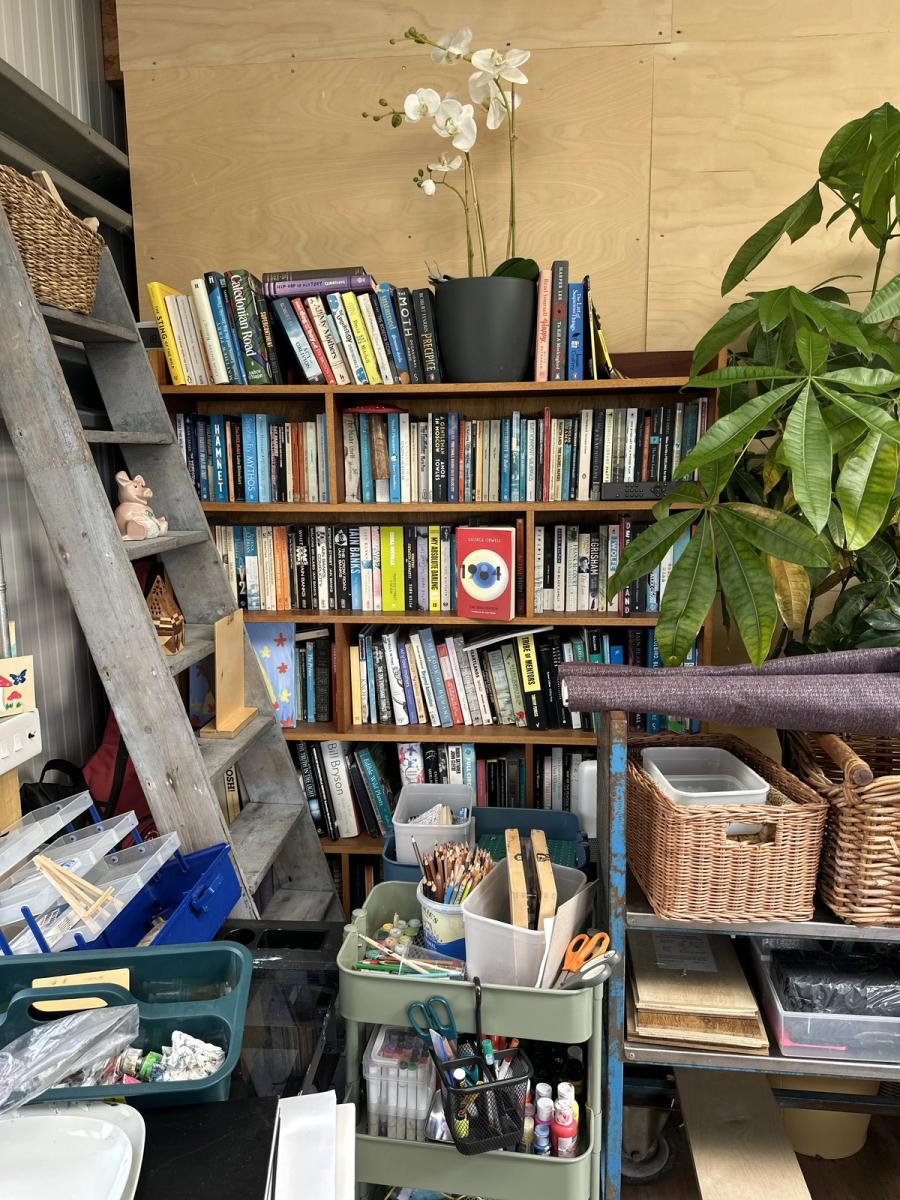 The shed at Bothan Jura Retreat, Isle of Jura — bookshelves, plants, pencils and the making table