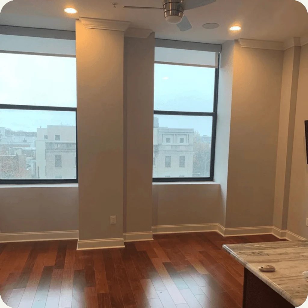Light interior with white trim, tall windows, and hardwood flooring