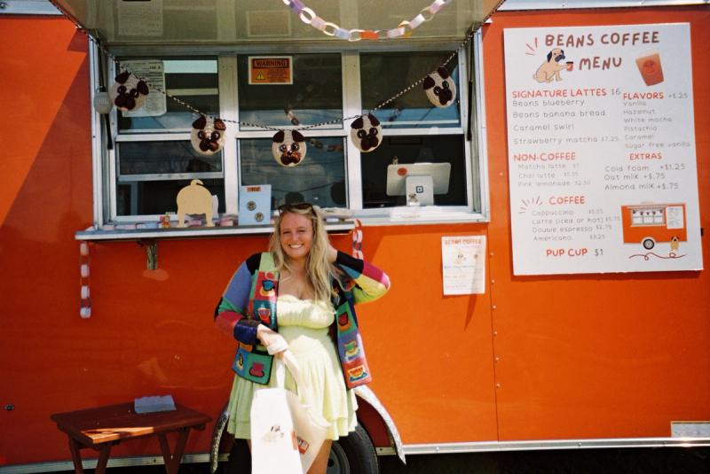 Cassidy standing in front of the Beans Coffee trailer