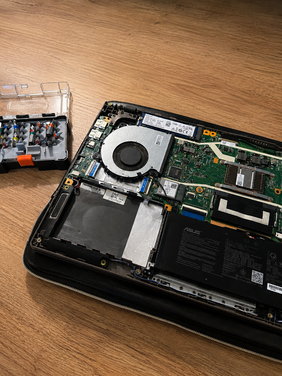 Open laptop with a disconnected Wi-Fi antenna cable during troubleshooting