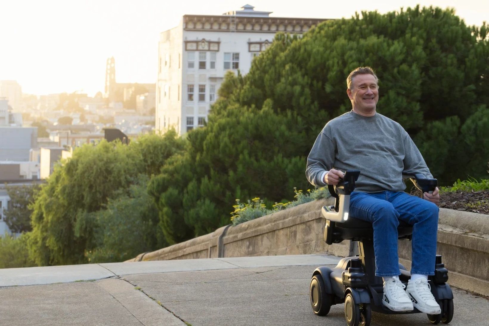 Person using the Strutt ev1c smart powered mobility device outdoors