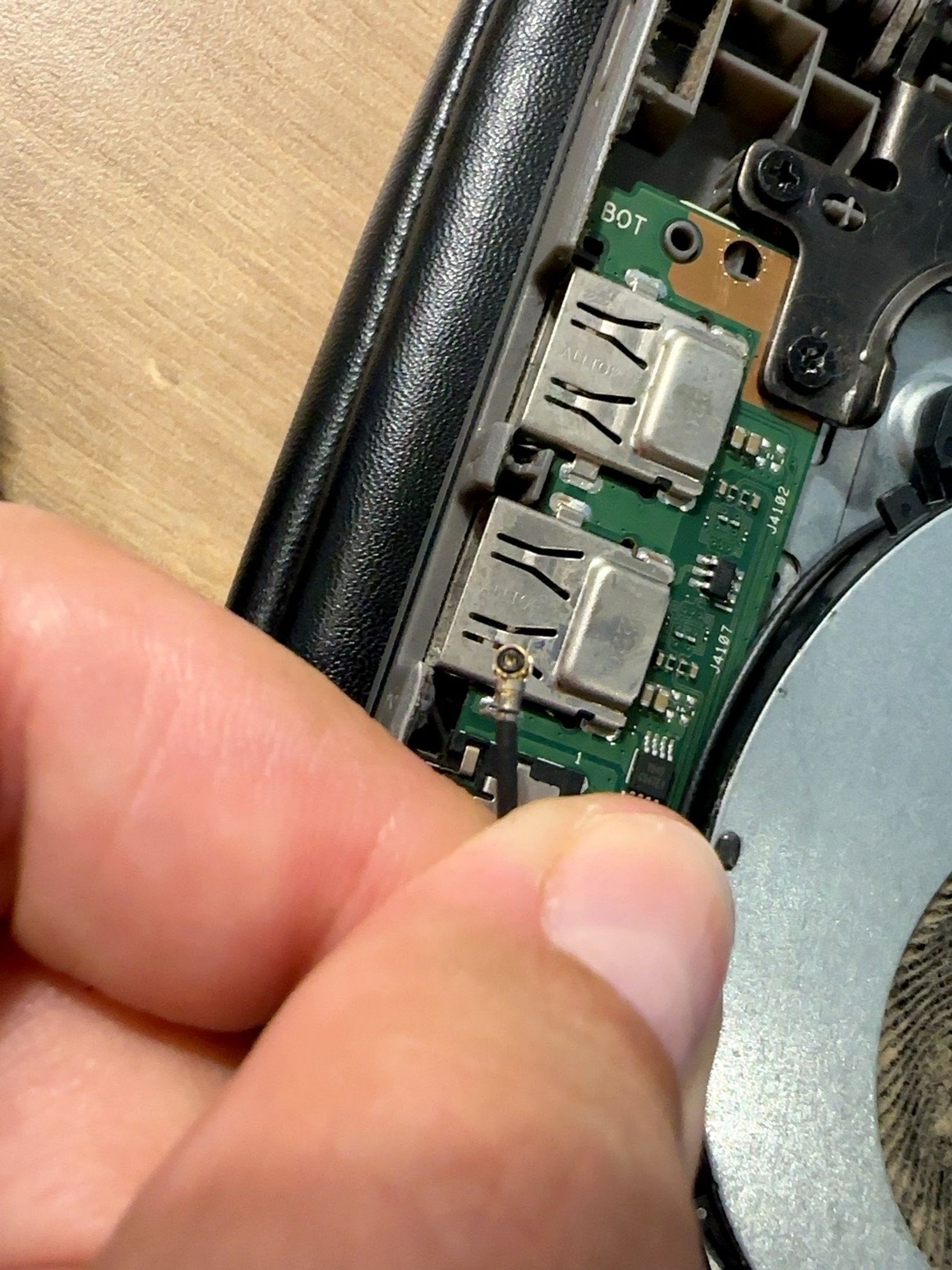 Close-up of the loose Wi-Fi antenna cable inside my laptop before reconnecting it