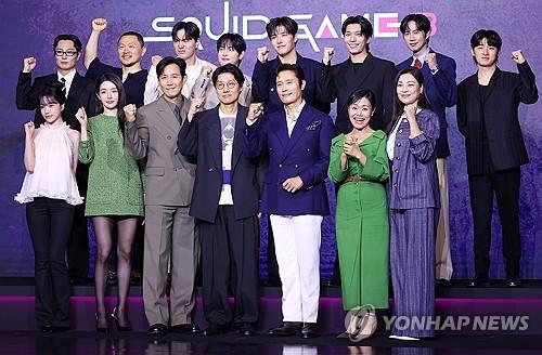 Cast members and director Hwang Dong-hyuk (C, 1st row) pose for photos during a press conference in Seoul on June 9, 2025. (Yonhap)
