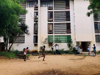 Children playing in a dirt courtyard