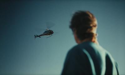 Scott Jurek looking up at a helicopter