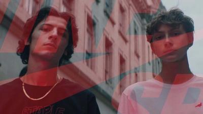 Two skateboarders pose for a portrait 