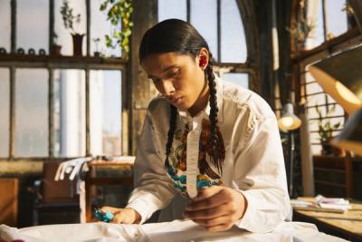 Person working at their desk wearing Beats headphones