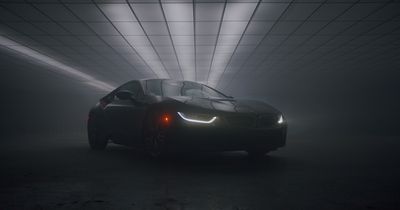 a BMW is parked in the haze