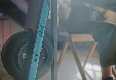 a onewheel rideable devices leans against a desk