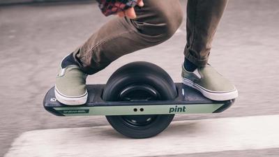 A person is riding a Onewheel
