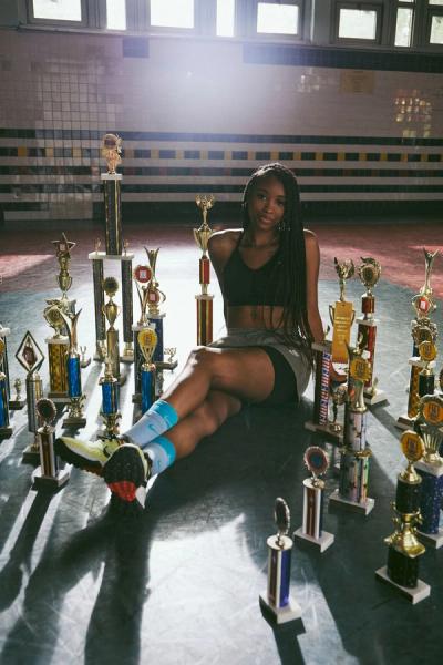 Young woman sitting with her double dutch trophies