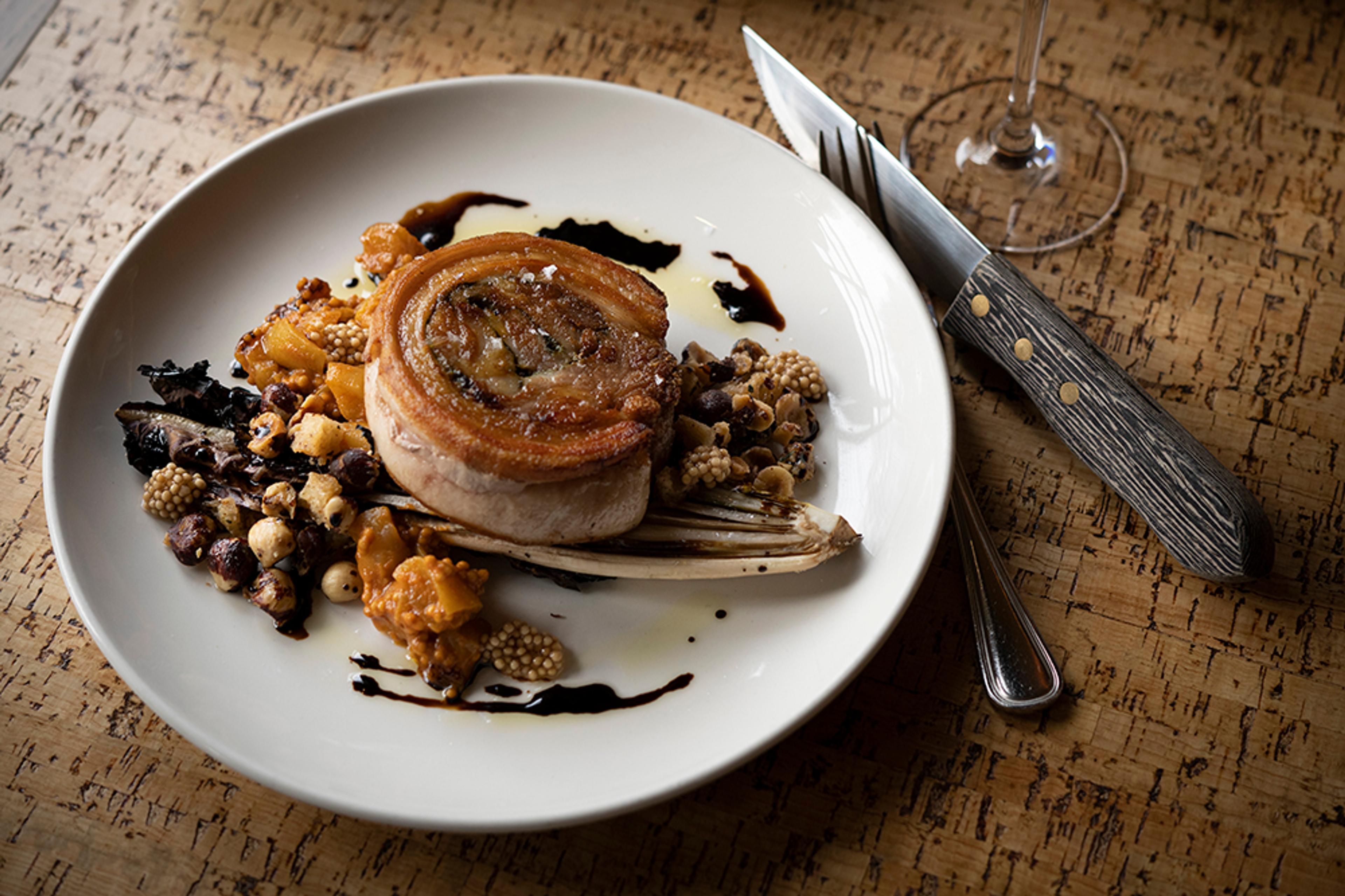 pan roasted porchetta over grilled endive with hazelnuts