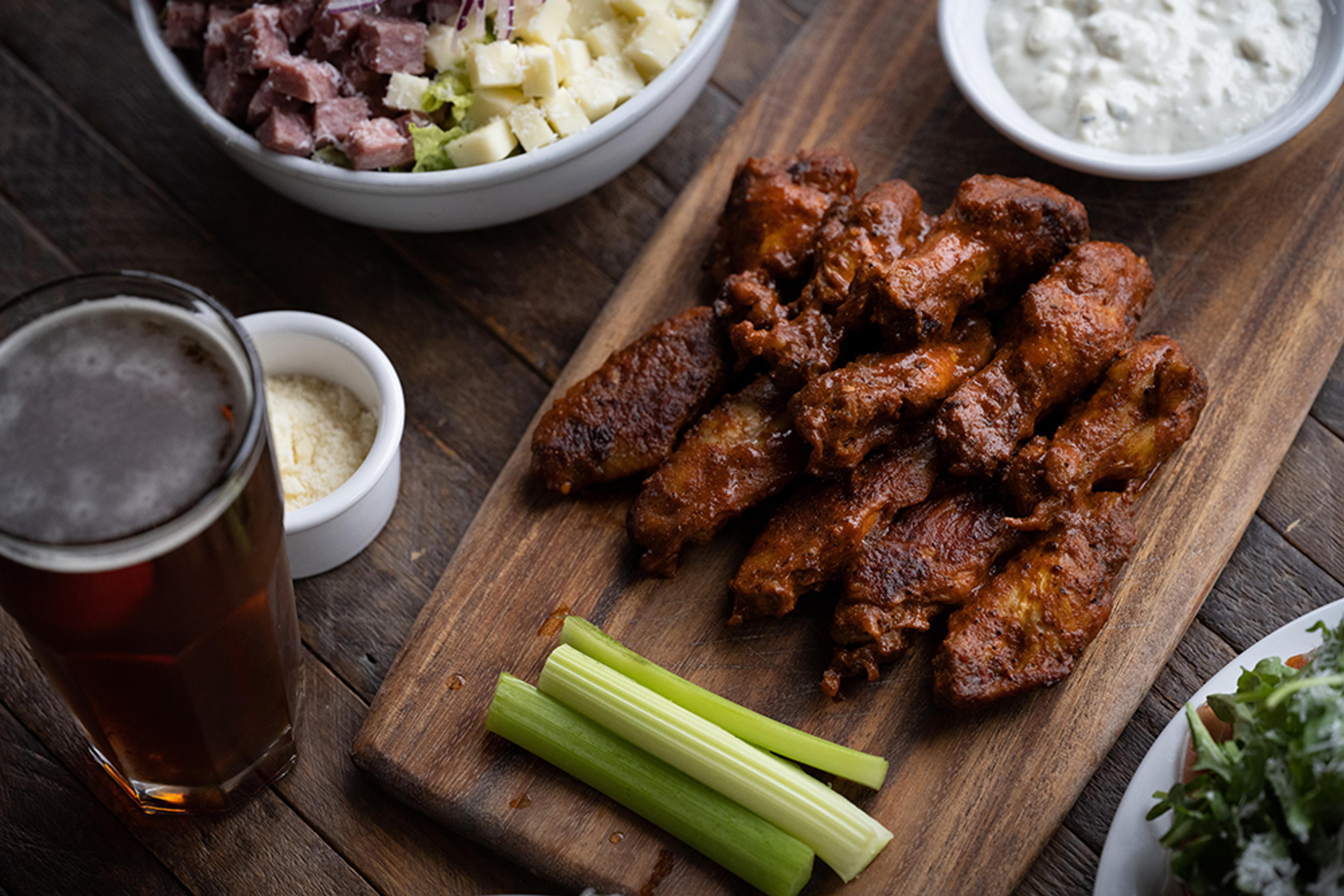 Spicy chicken wings accompanied by pint of beer