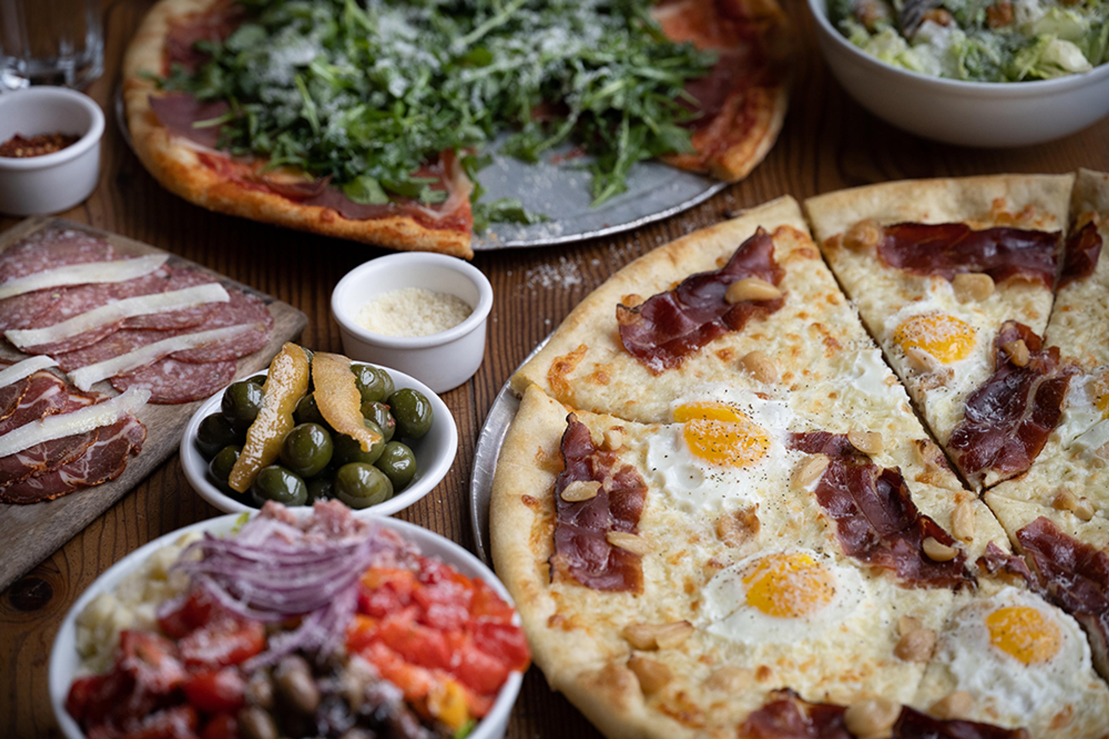 carbonara pizza with eggs, crispy guanciale, and garlic