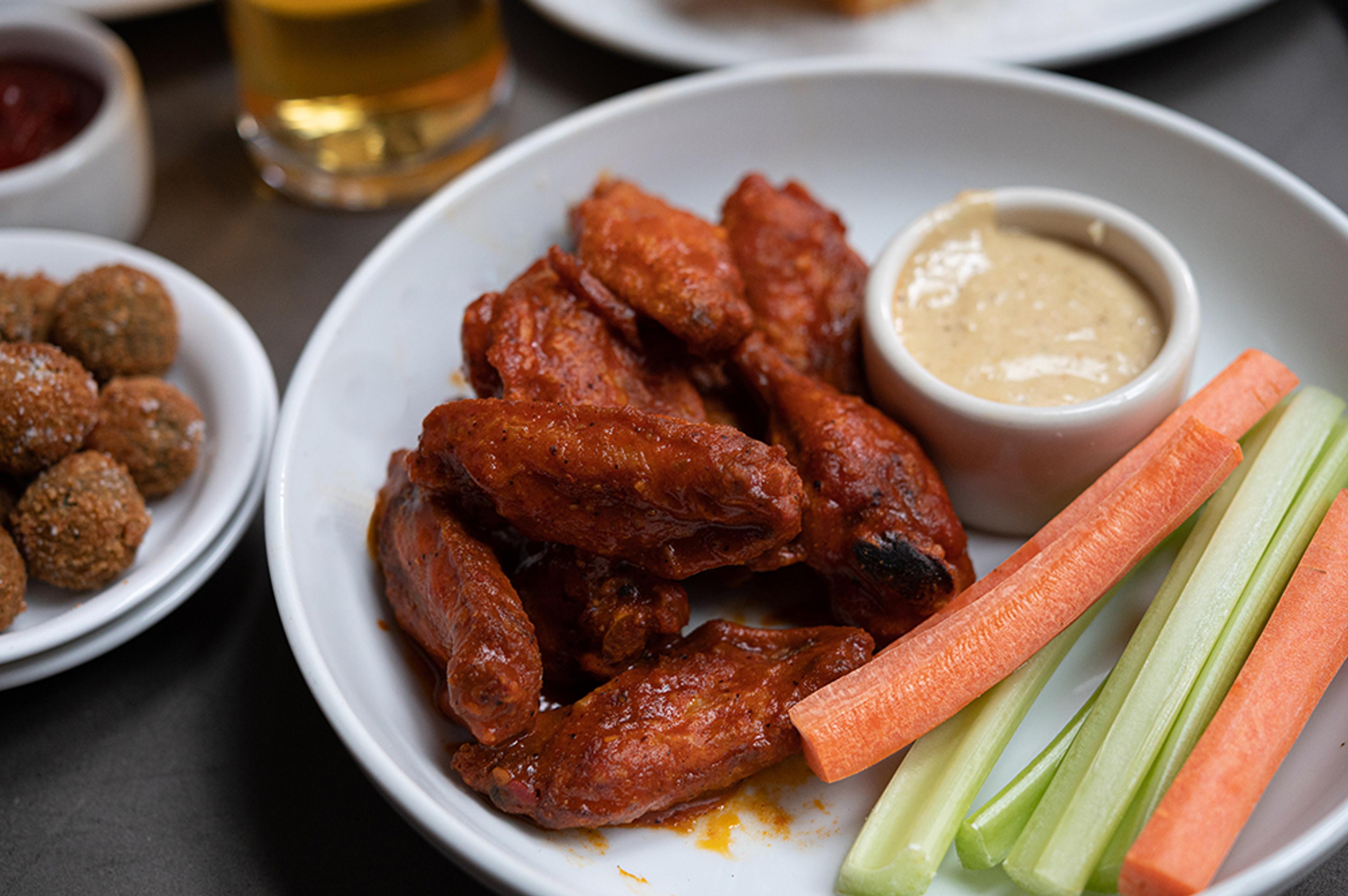 spicy buffalo chicken wings with celery, carrots, and blue cheese dressing