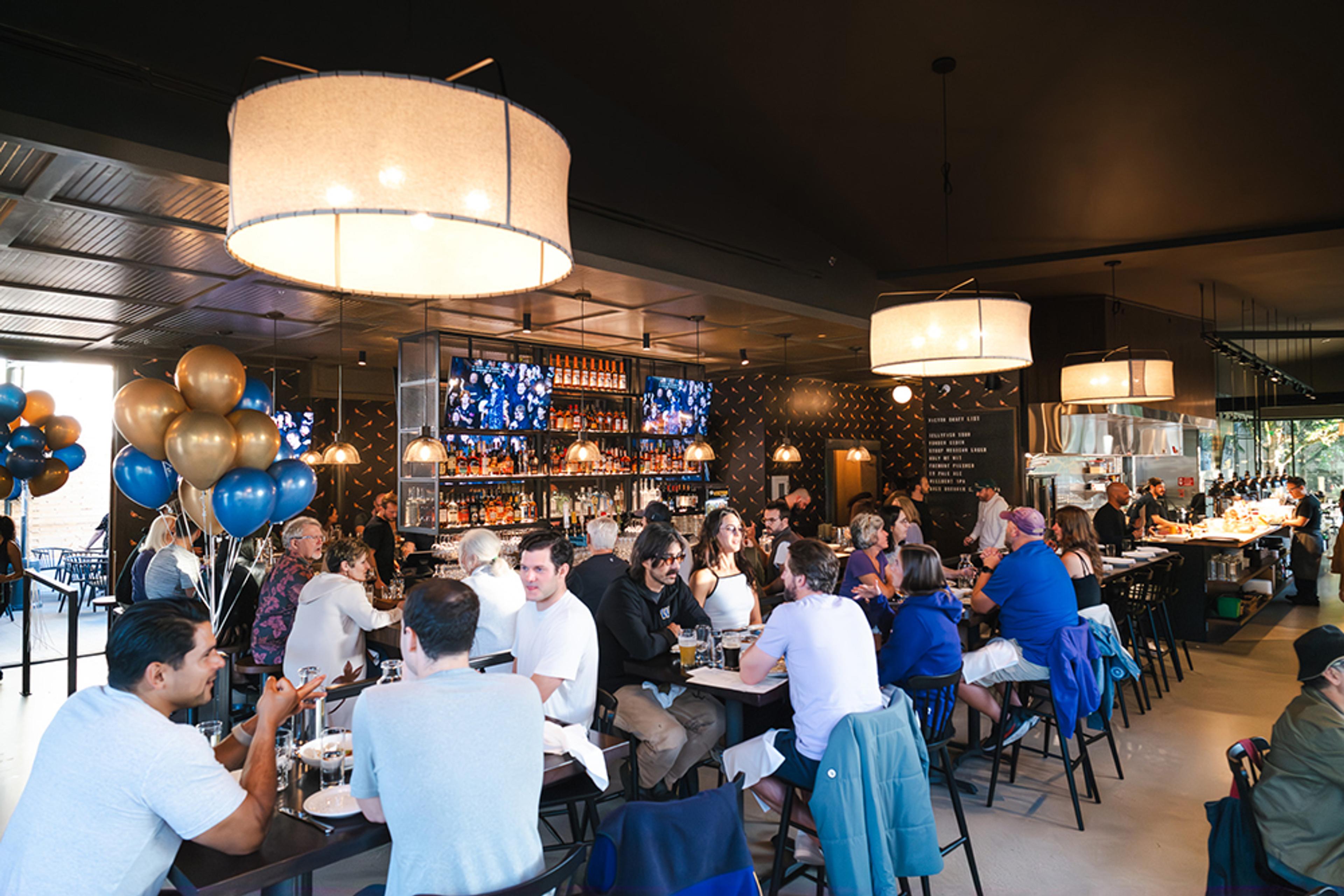 large festive room with people eating and drinking