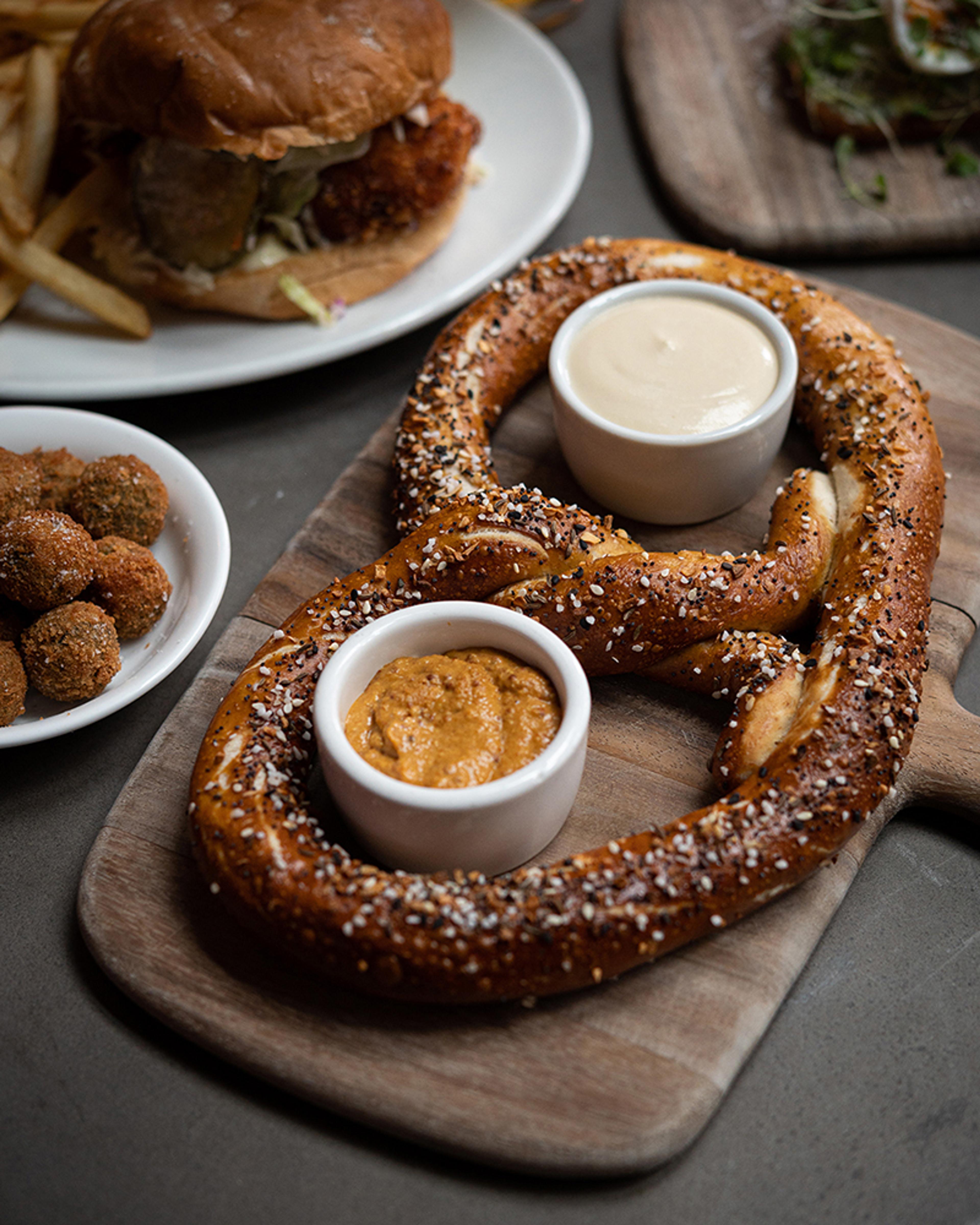 large pretzel with cheese sauce and house mustard
