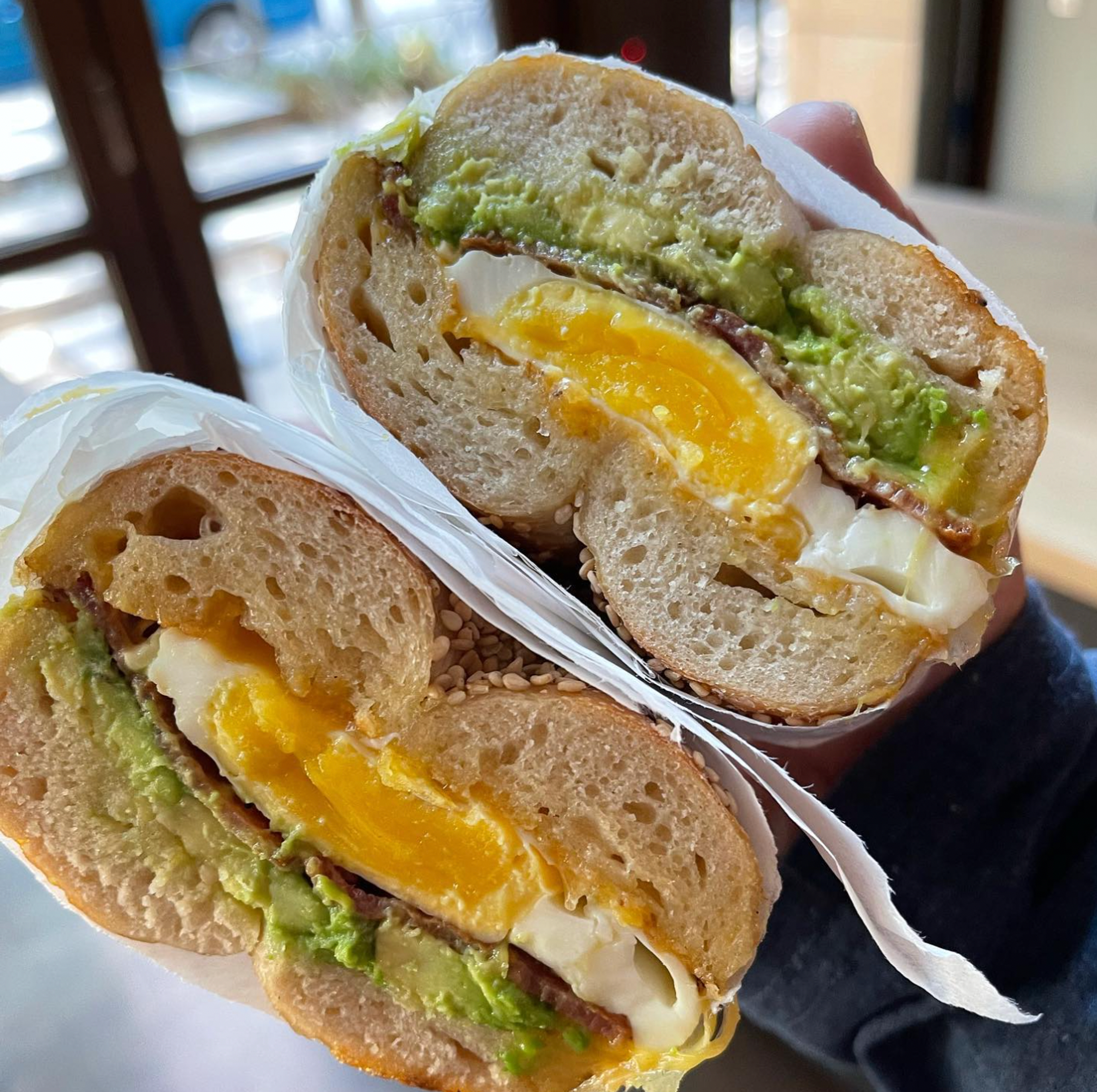 egg and cheese bagel sandwich with avocado