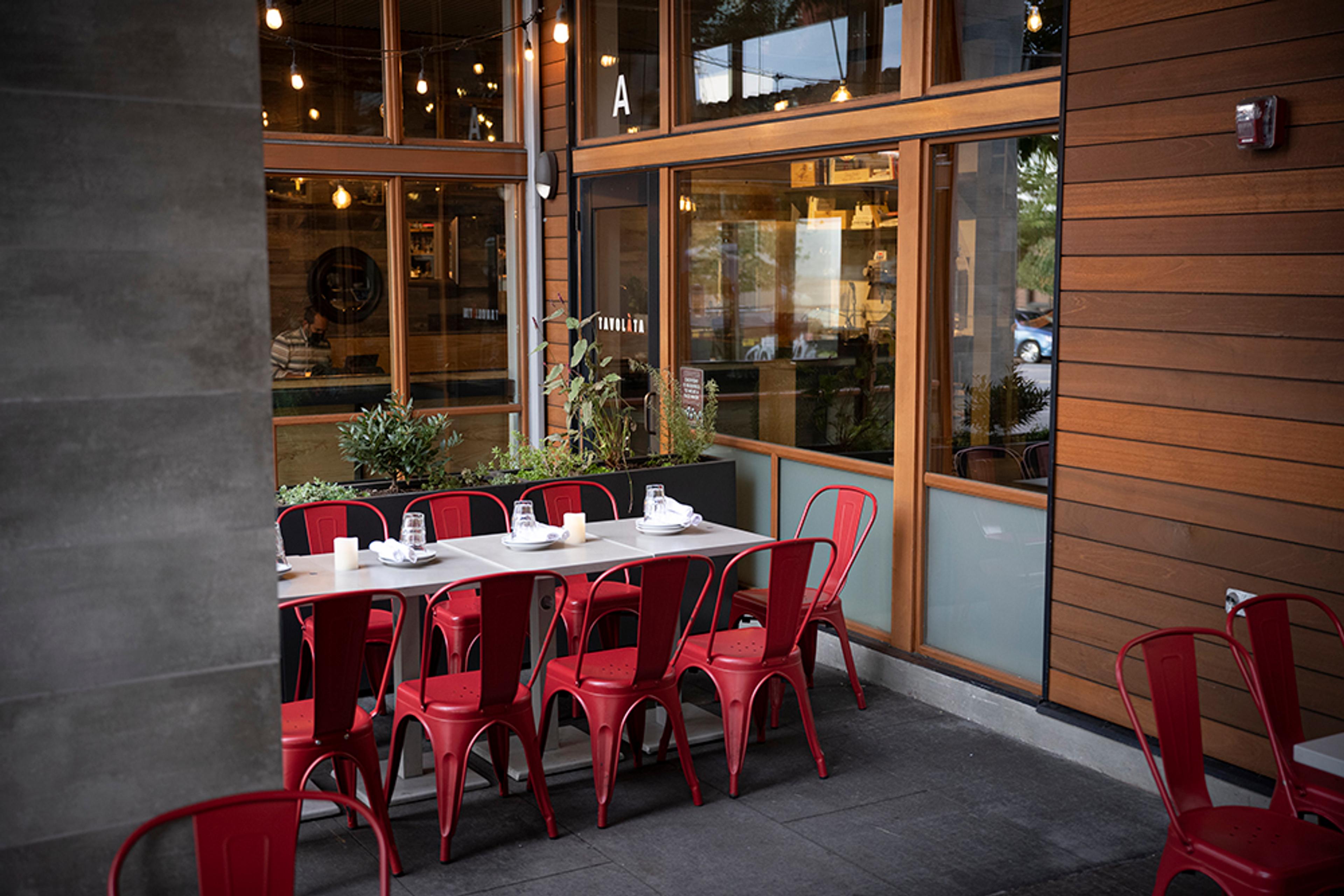 patio tables with wooded walls and red chars