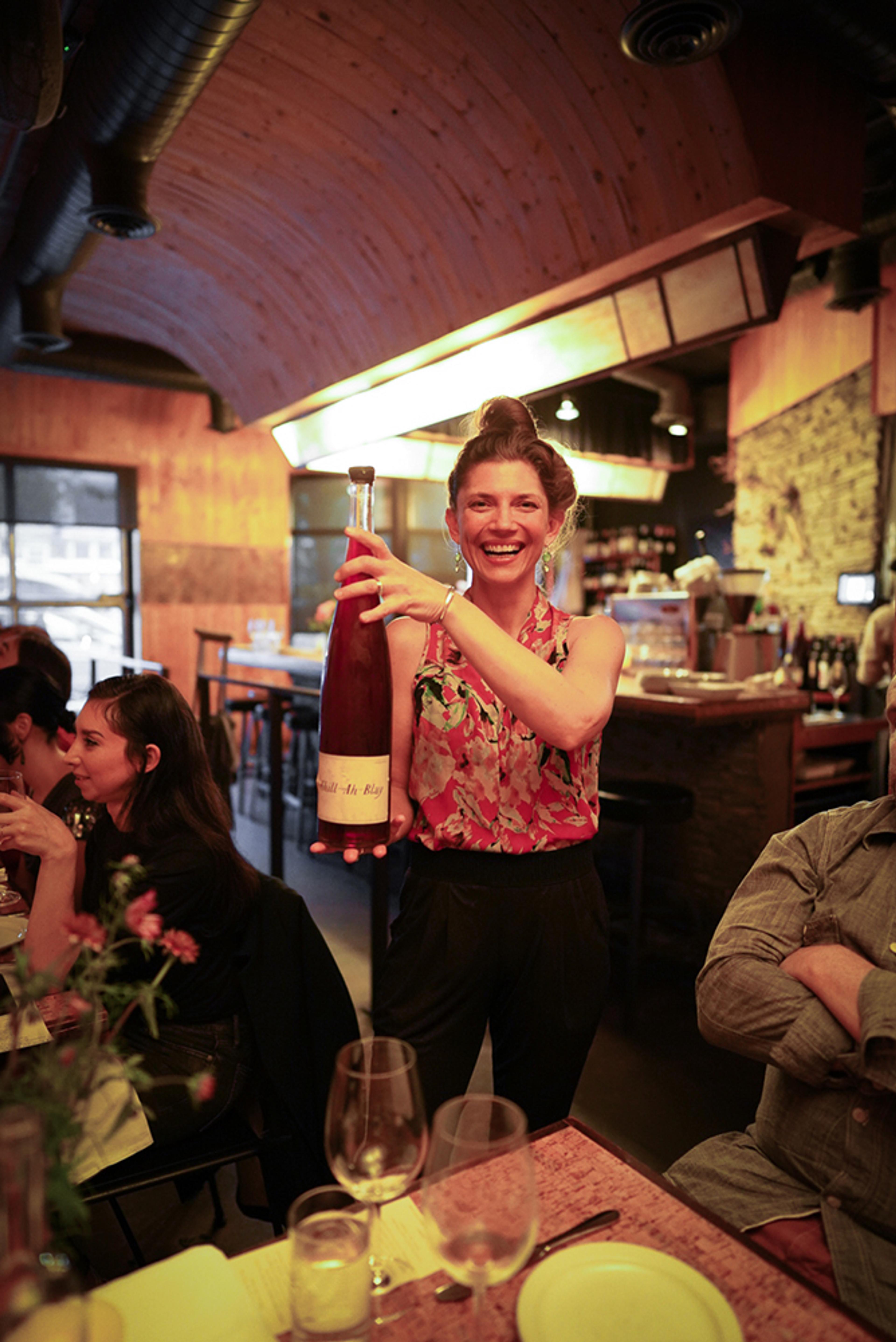 Restaurant manager with magnum bottle of natural wine