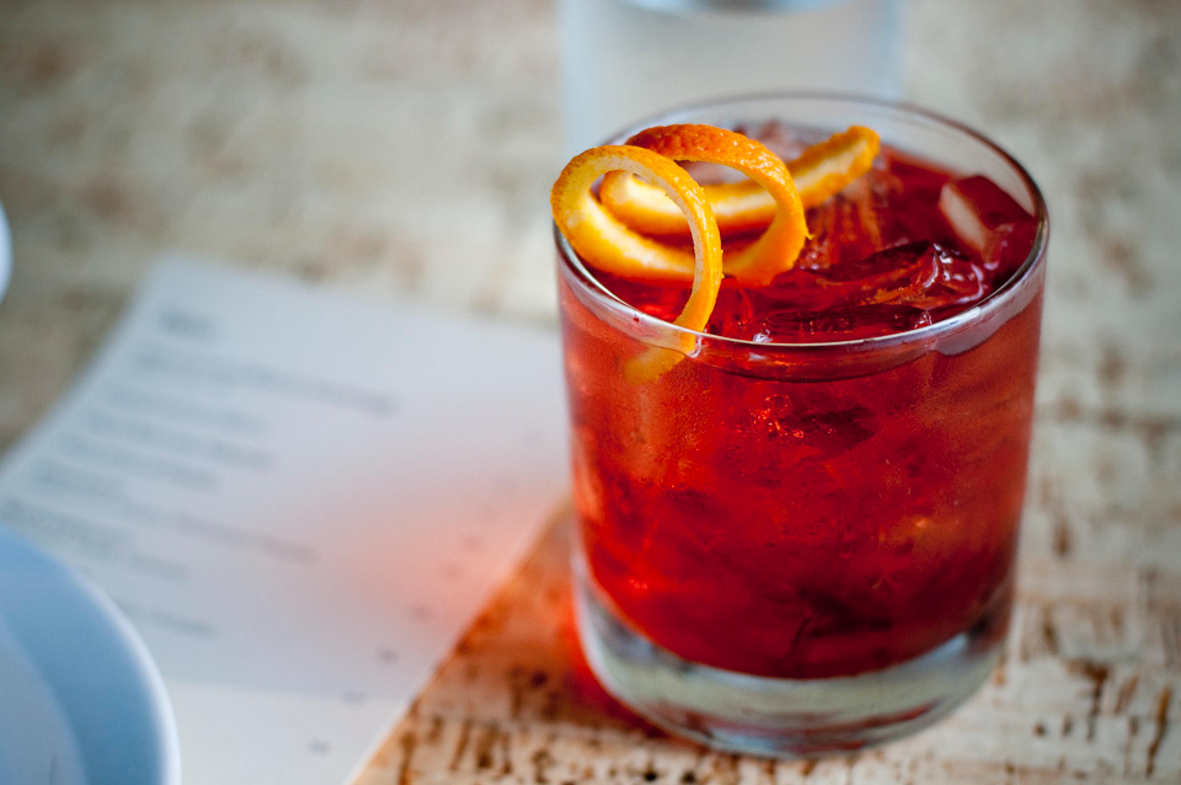 Negroni cocktail on the rocks with orange twist 