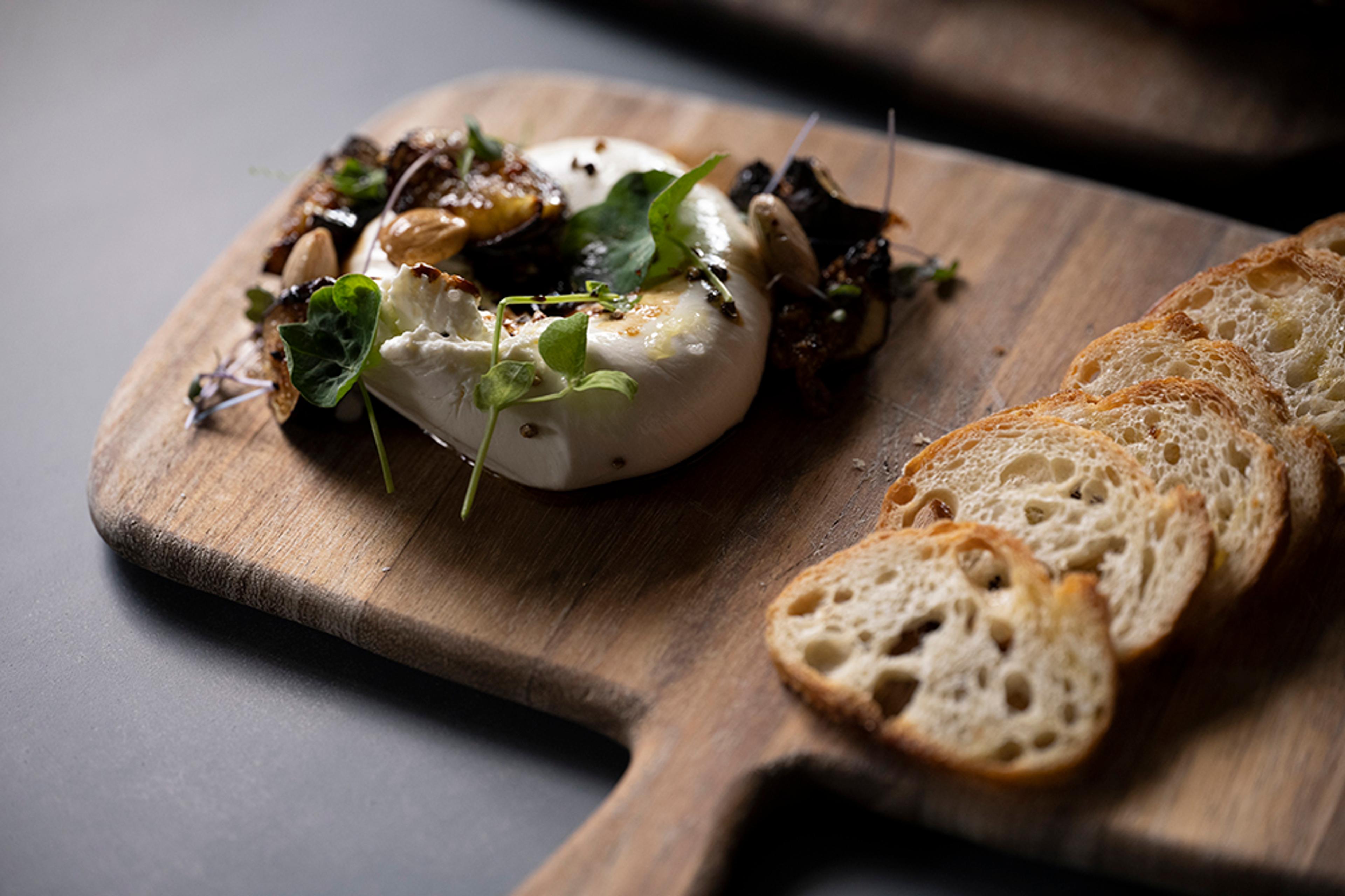 burrata with dates, Marconi almonds, micro greens and toasted crostini