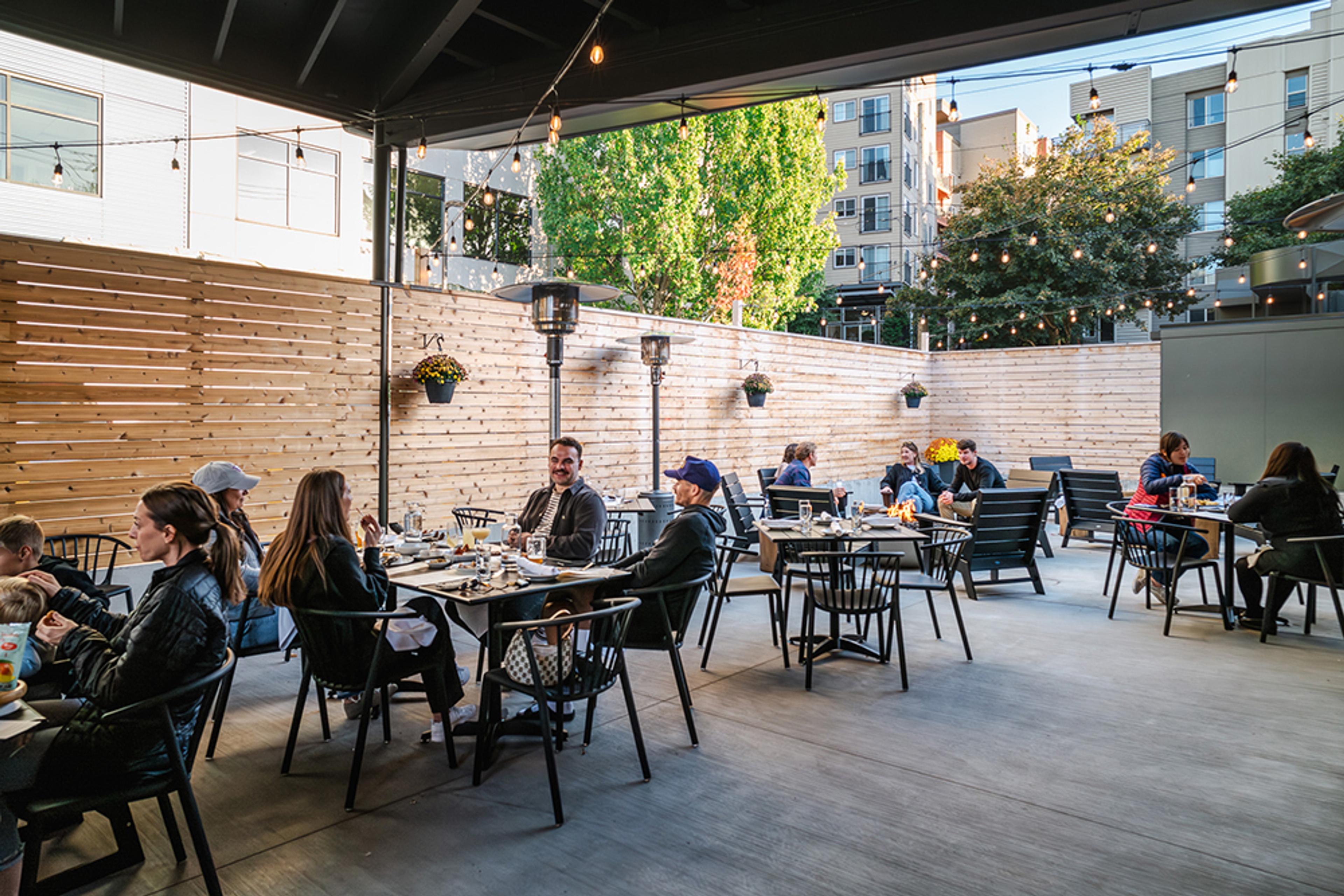 large outdoor patio with people eating and drinking