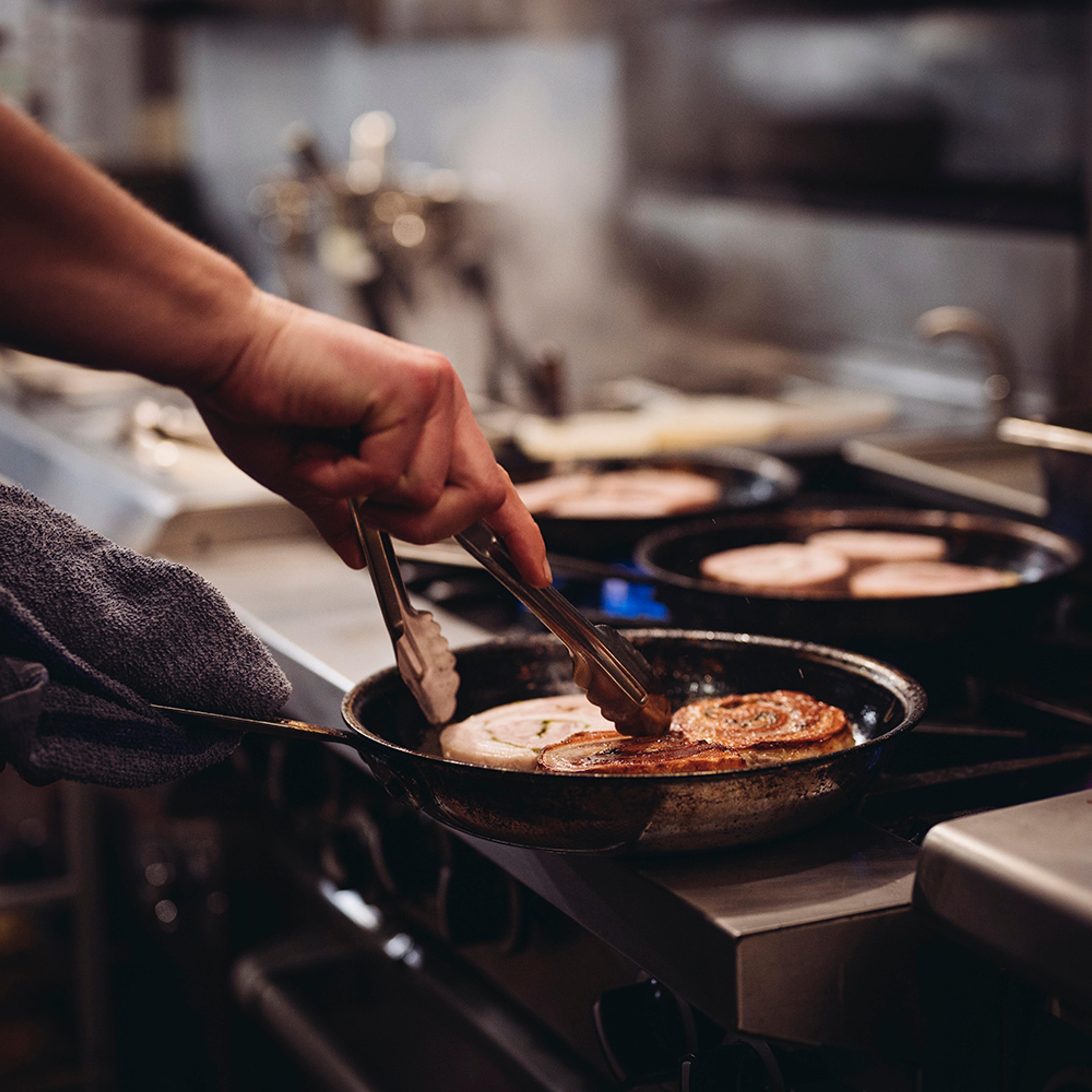 chef roasting porchetta in pan