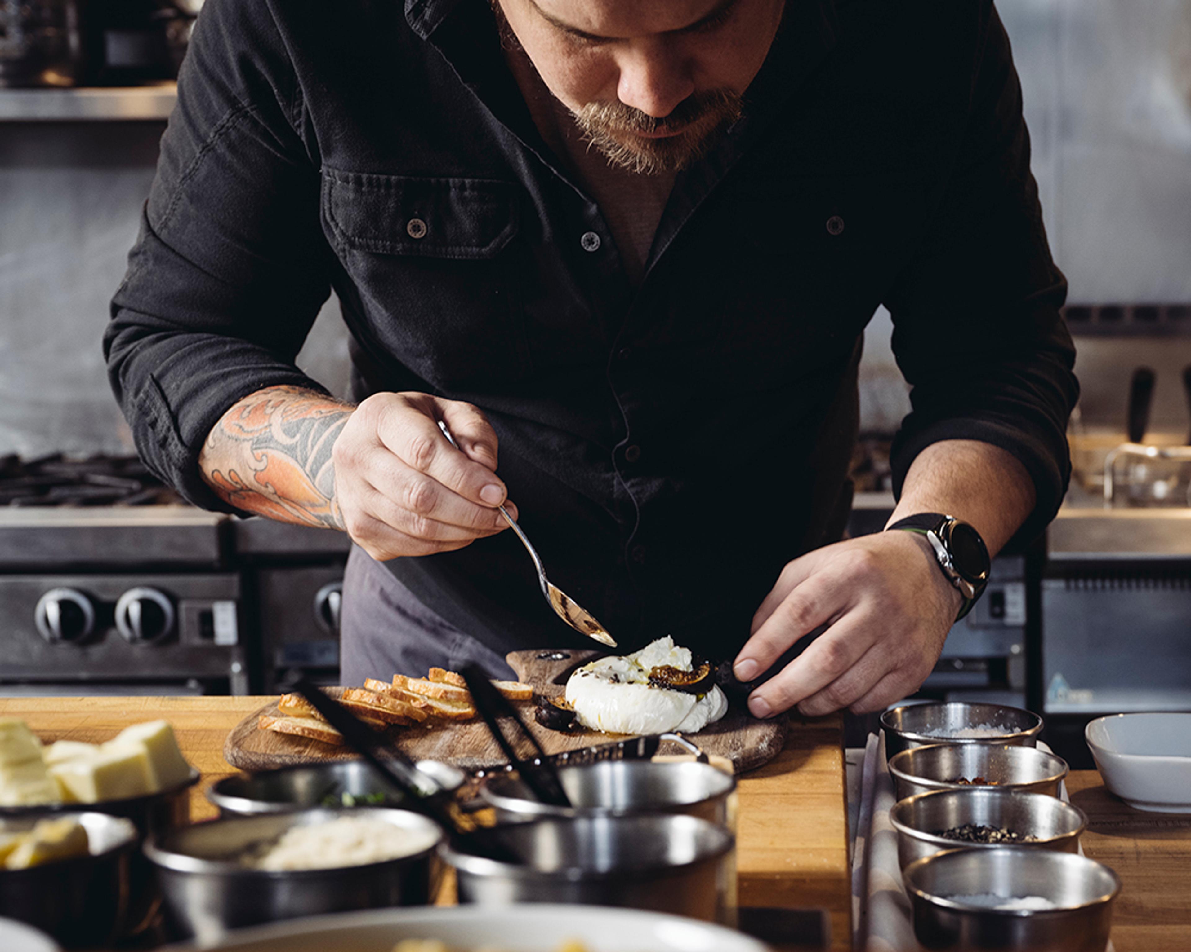 Chef meticulously plating cheese dish