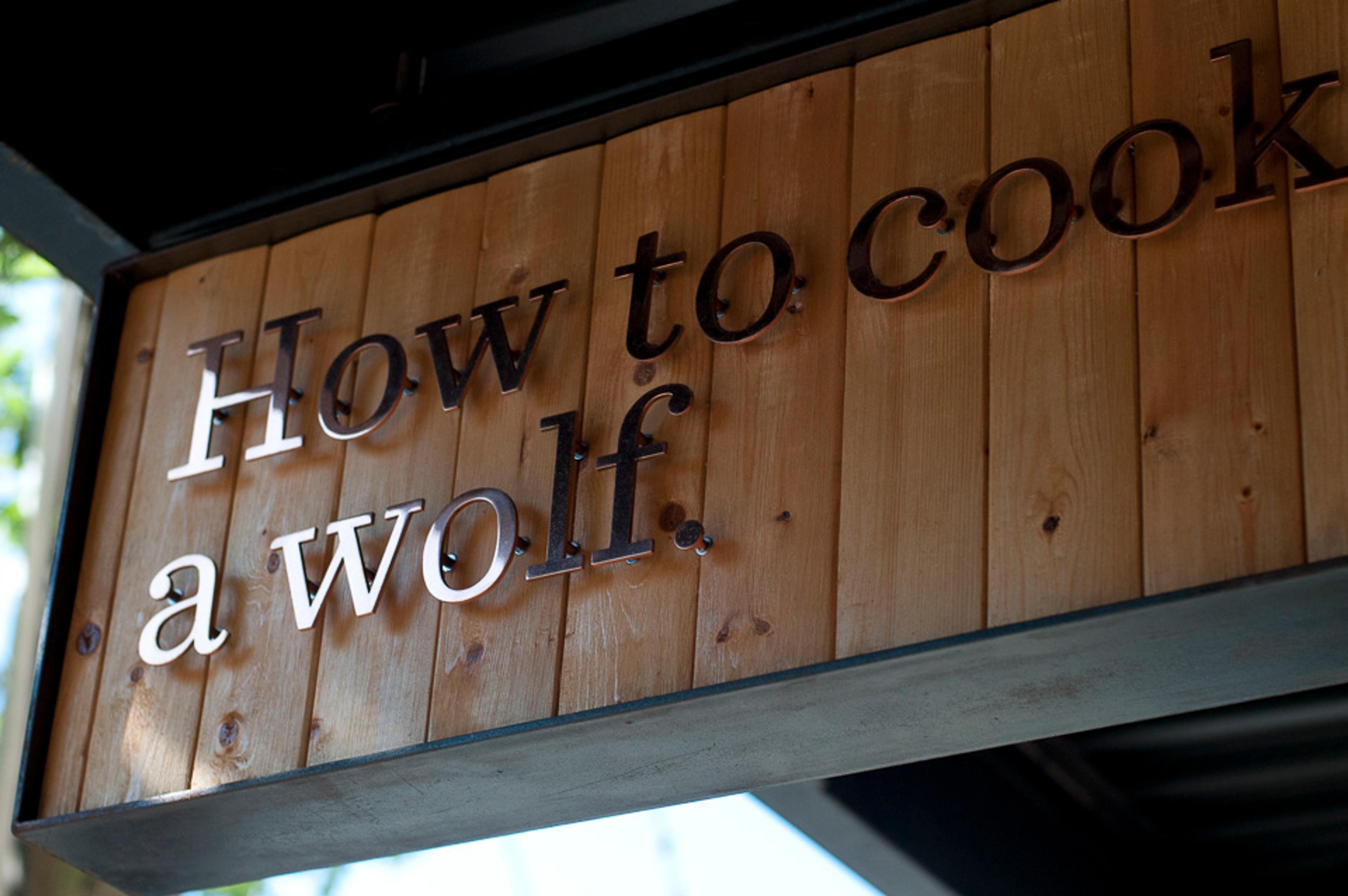 Restaurant awning sign with restaurant name in copper