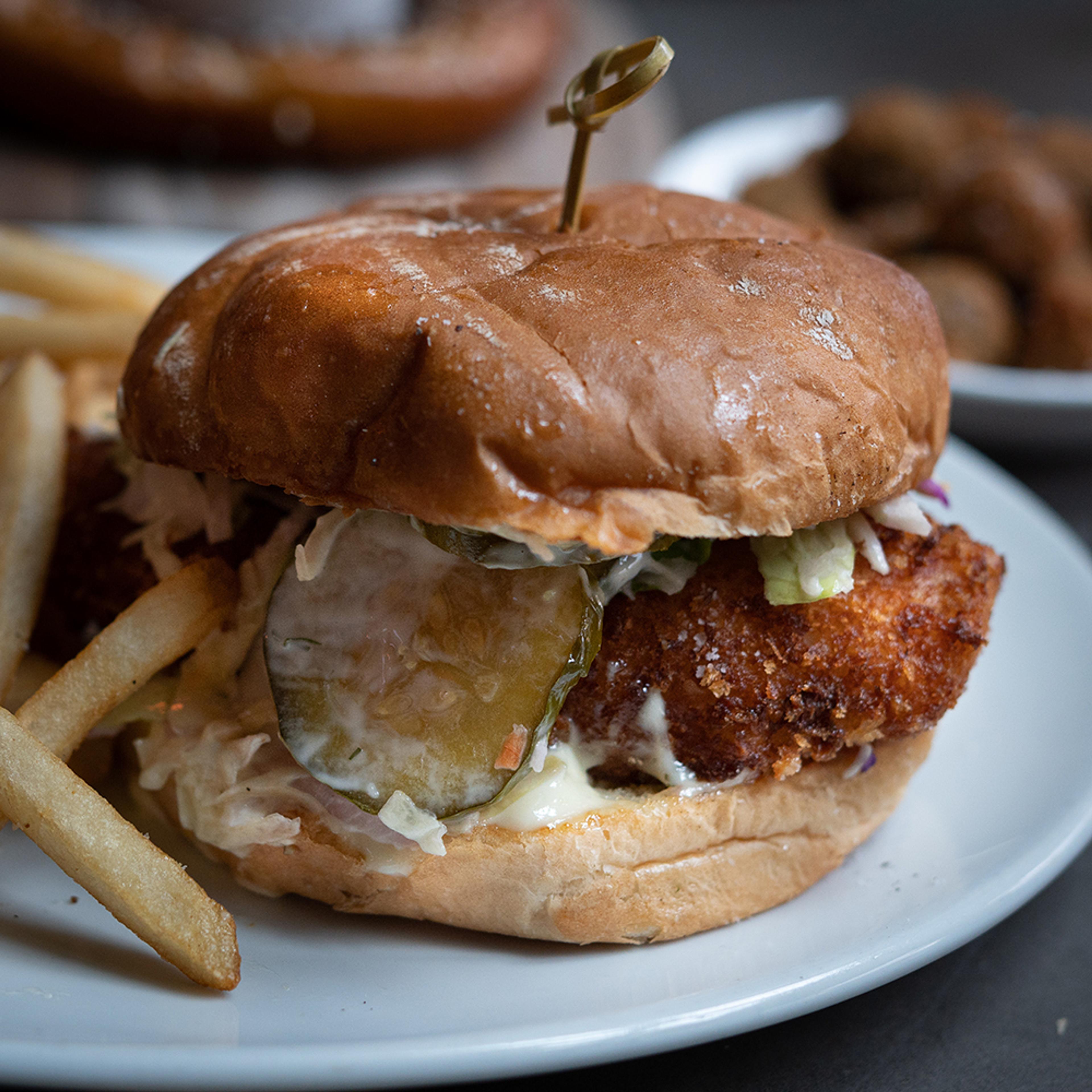 thick cut fried fish sandwich with pickles and fries