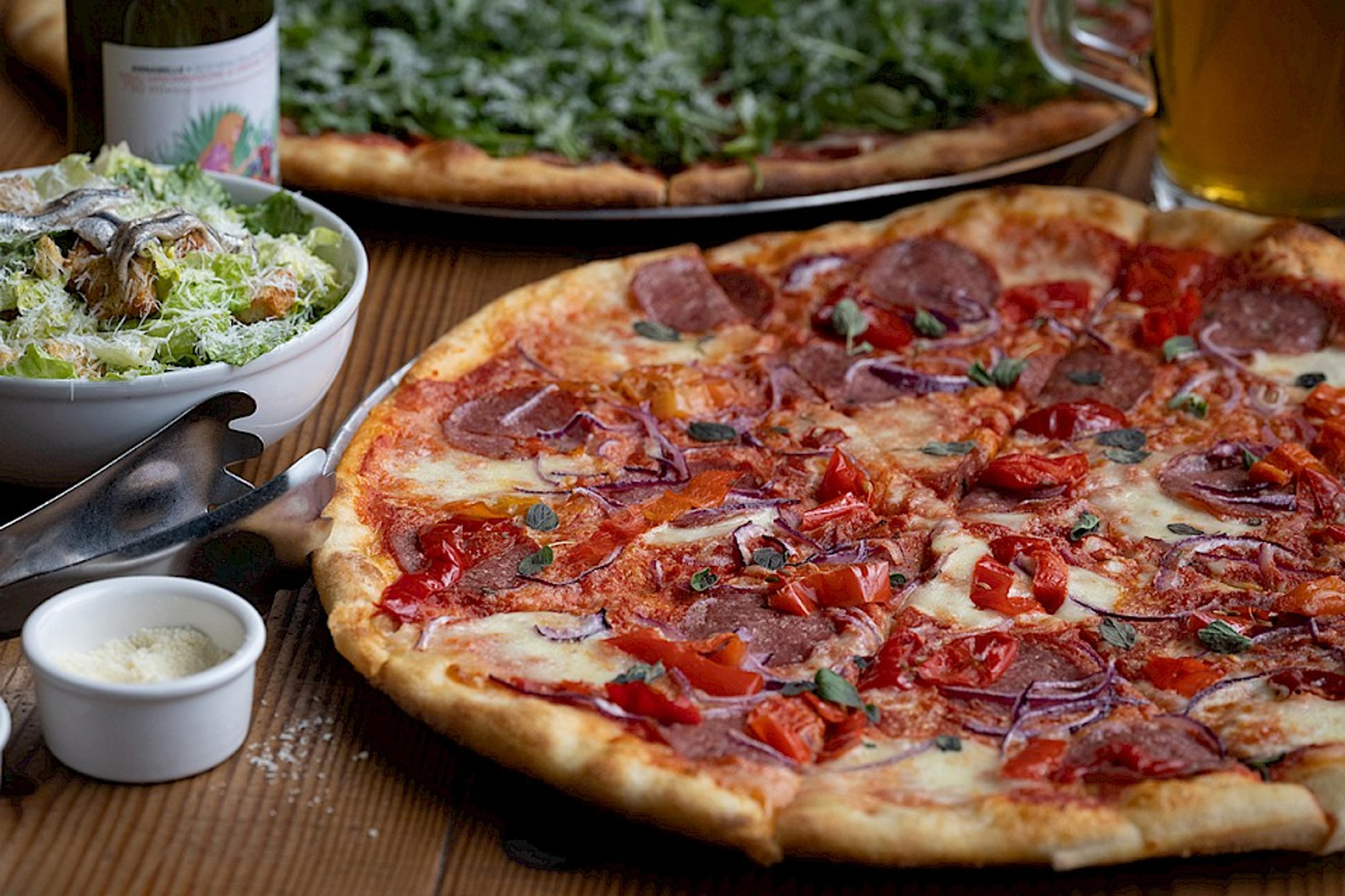 pizza with salami, red onion and sweet peppers