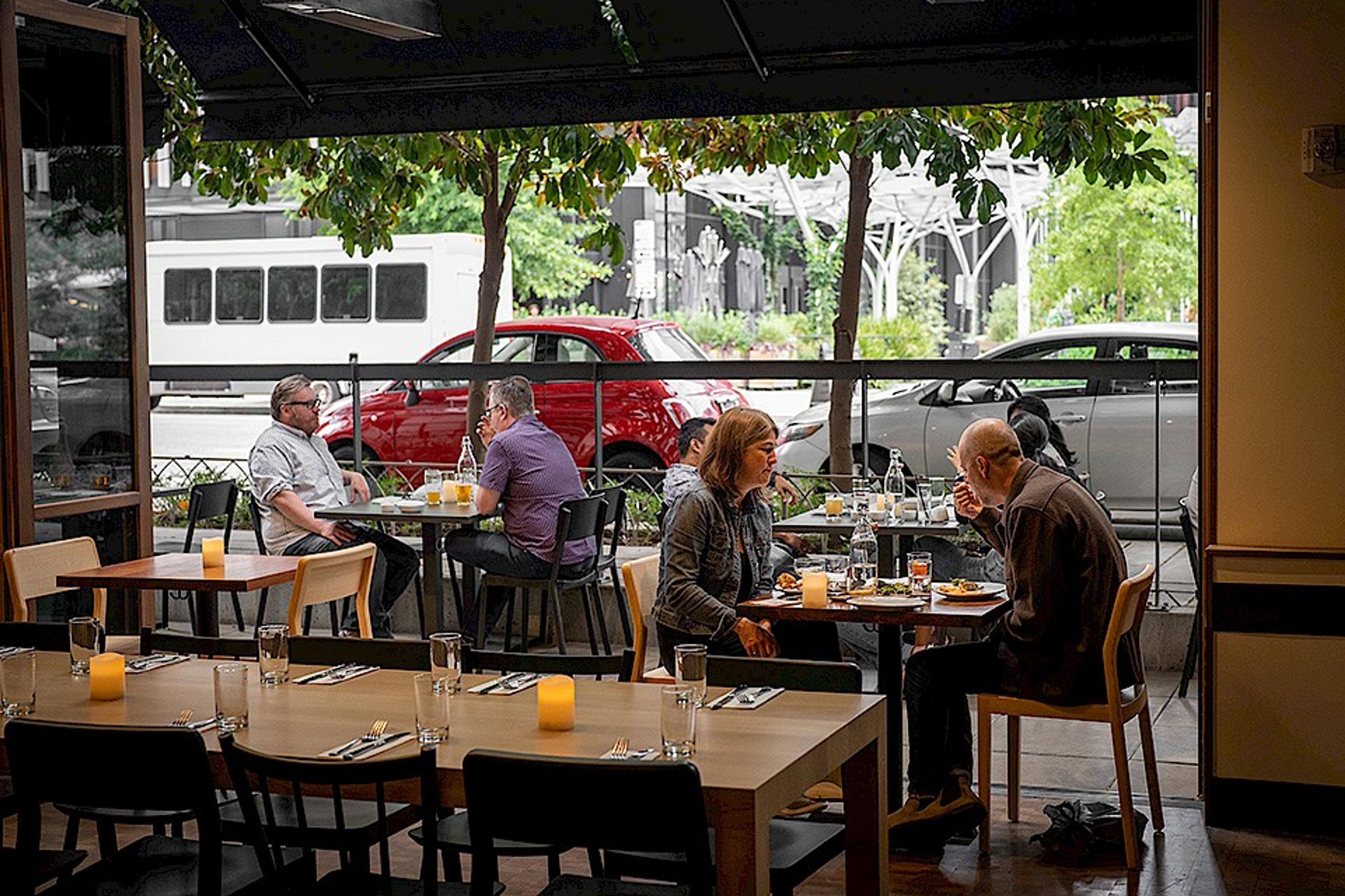 customers eating inside and outside of a large open retractable wall