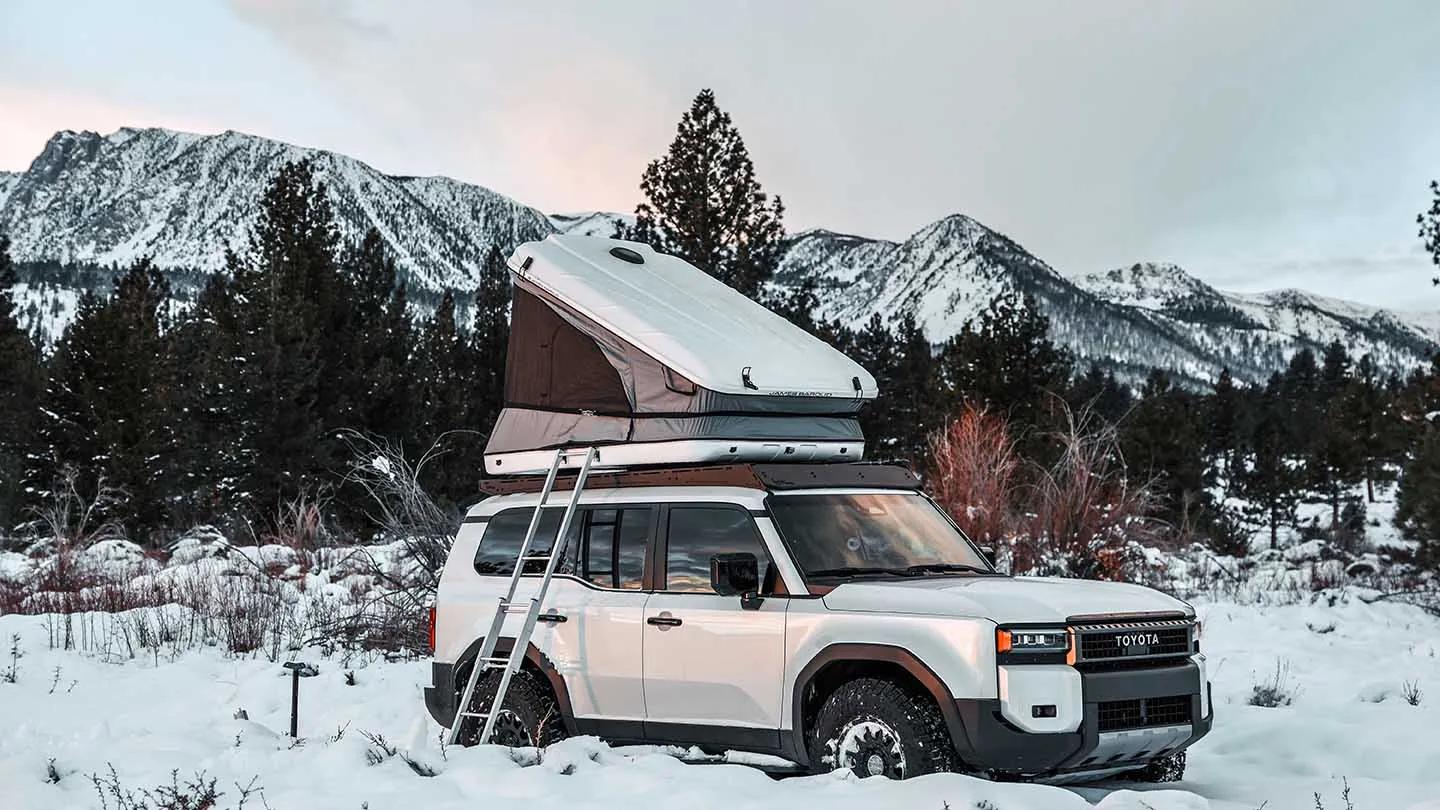 Hard-shell rooftop tent on a car in snow