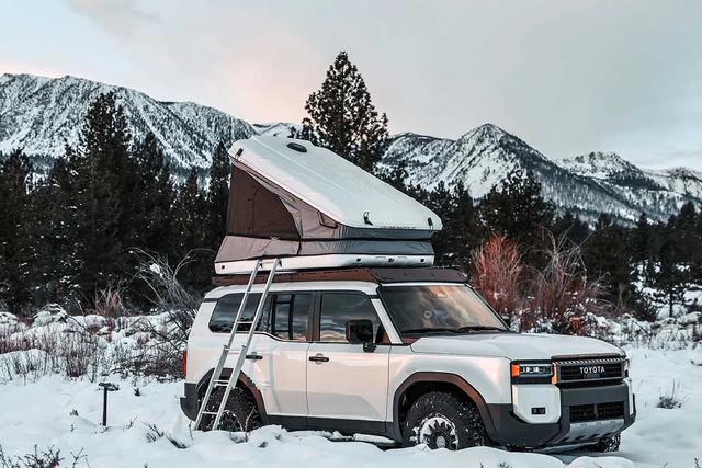 Hard-shell rooftop tent on a car in snow