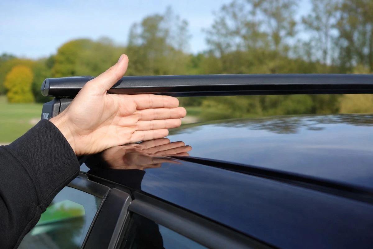 Palm-height gap between the car roof and roof bars, enough clearance to mount most rooftop tents