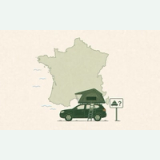 Green SUV with a rooftop tent in front of a map of France