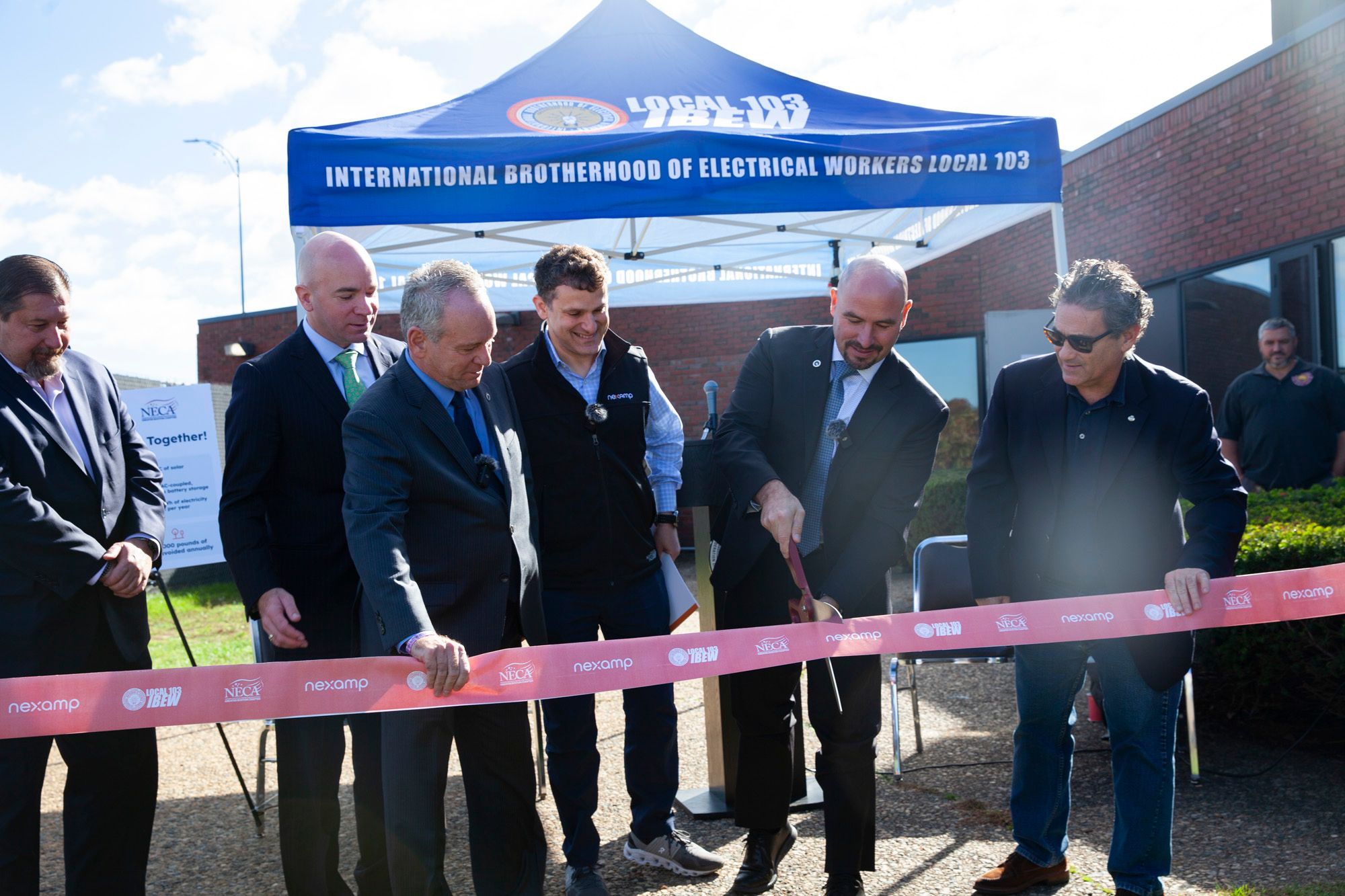 Officials cut the ribbon at IBEW Local 103 solar + storage project