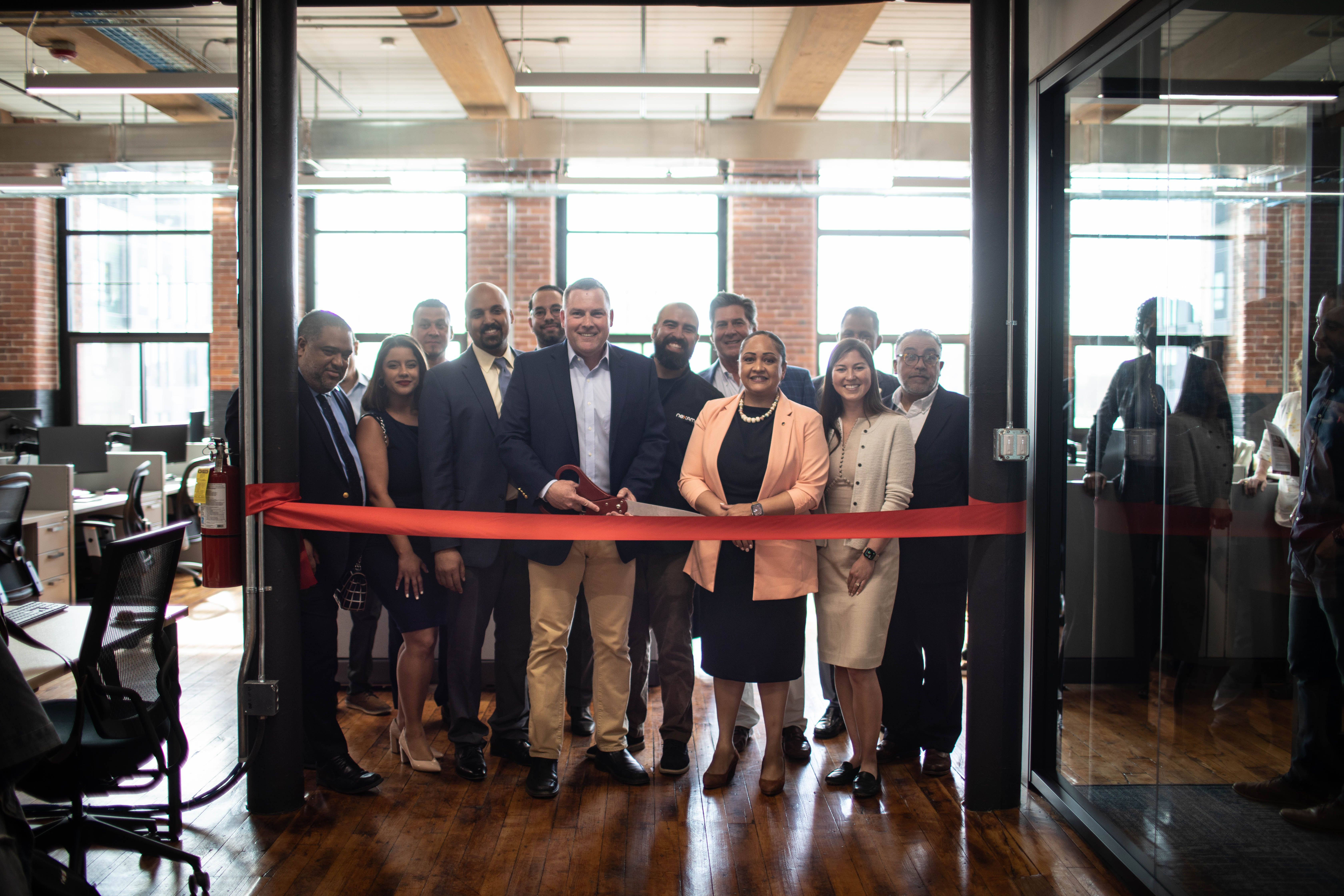 Nexamp leaders and local officials celebrate the opening of Nexamp's new space in Lawrence Mass.