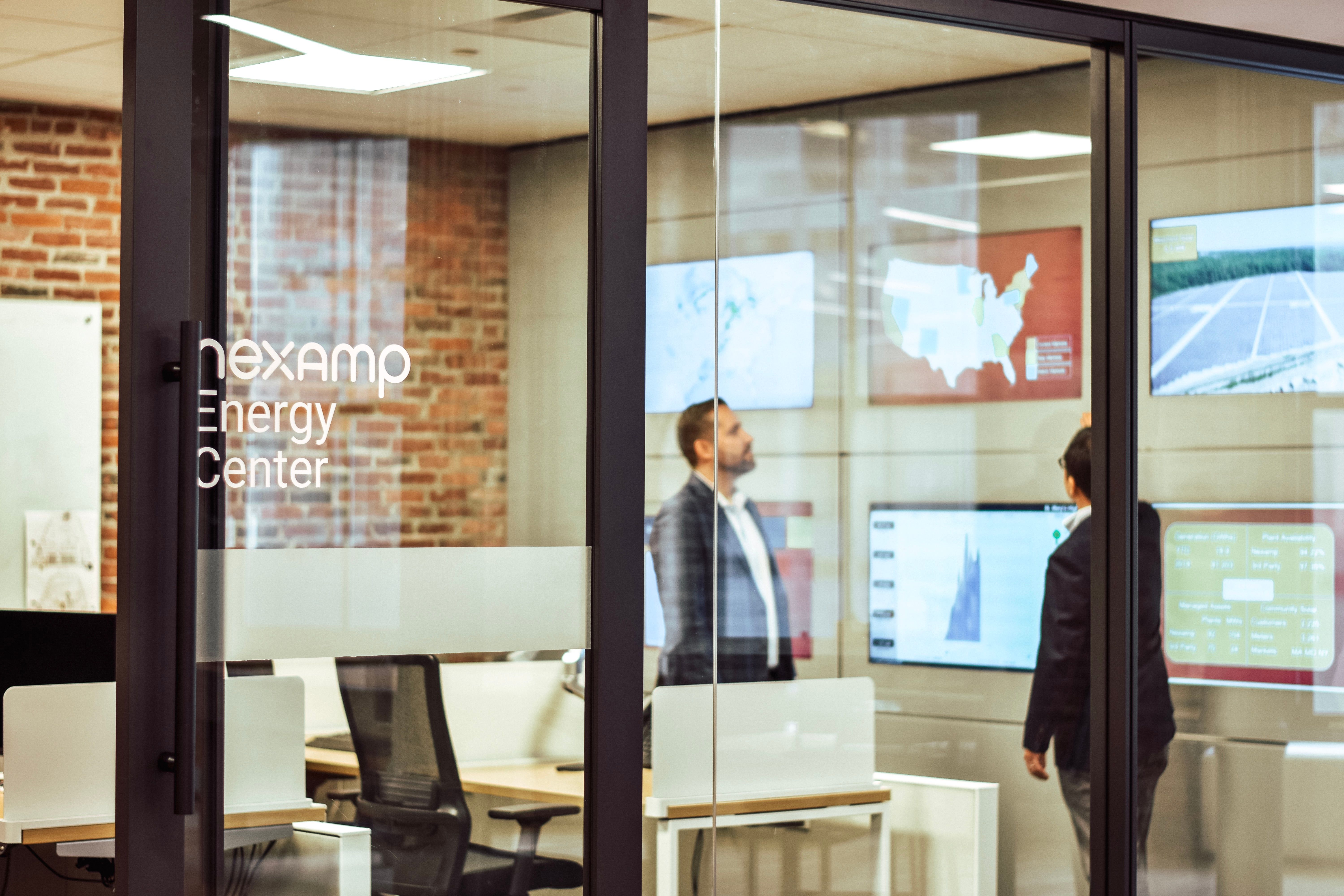 People next to solar panels