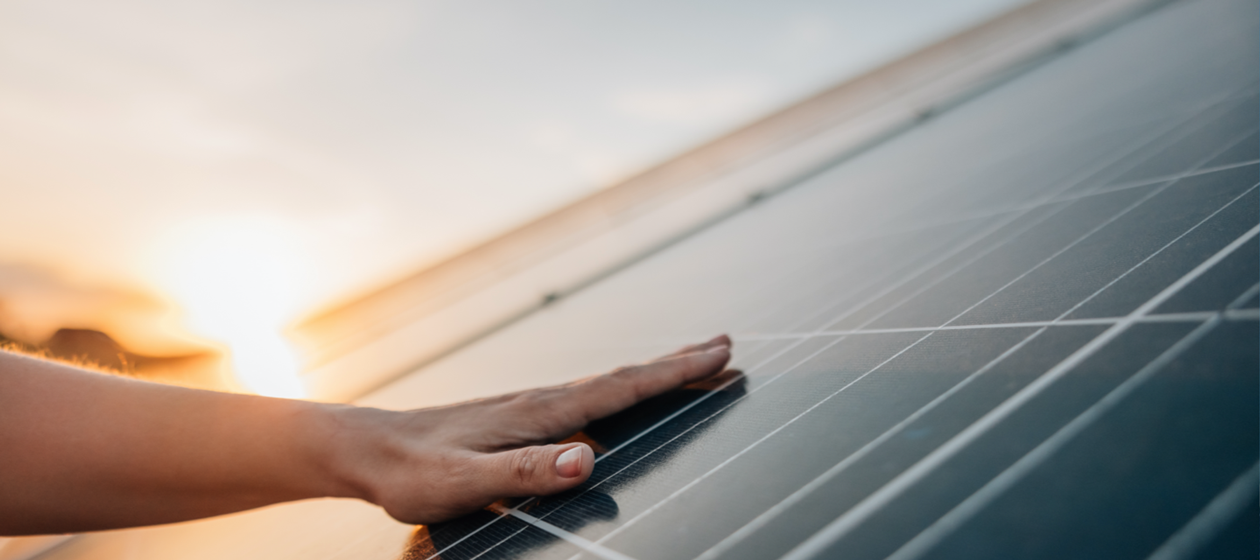 Hand touching a solar panel