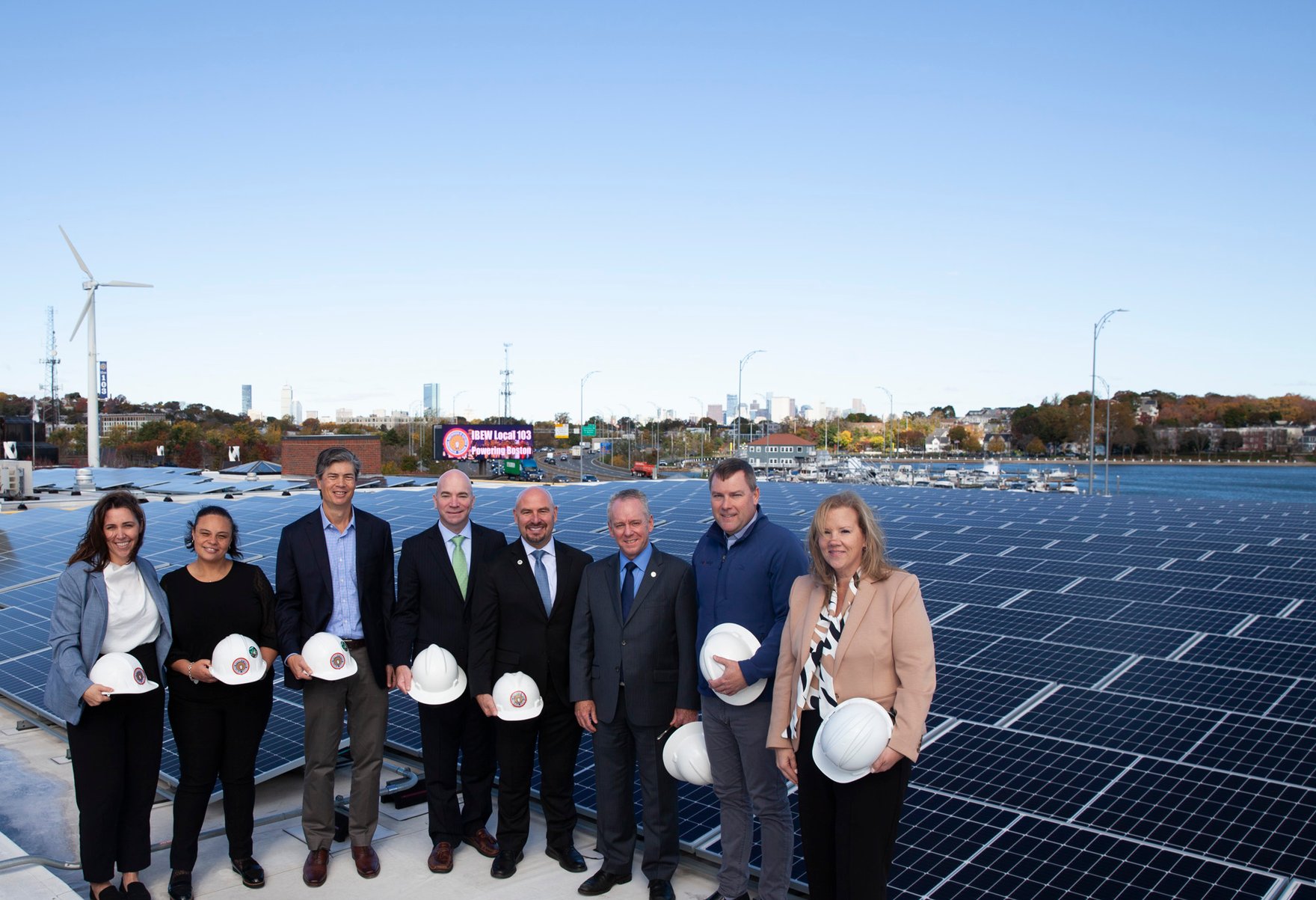 Executives view the rooftop solar array