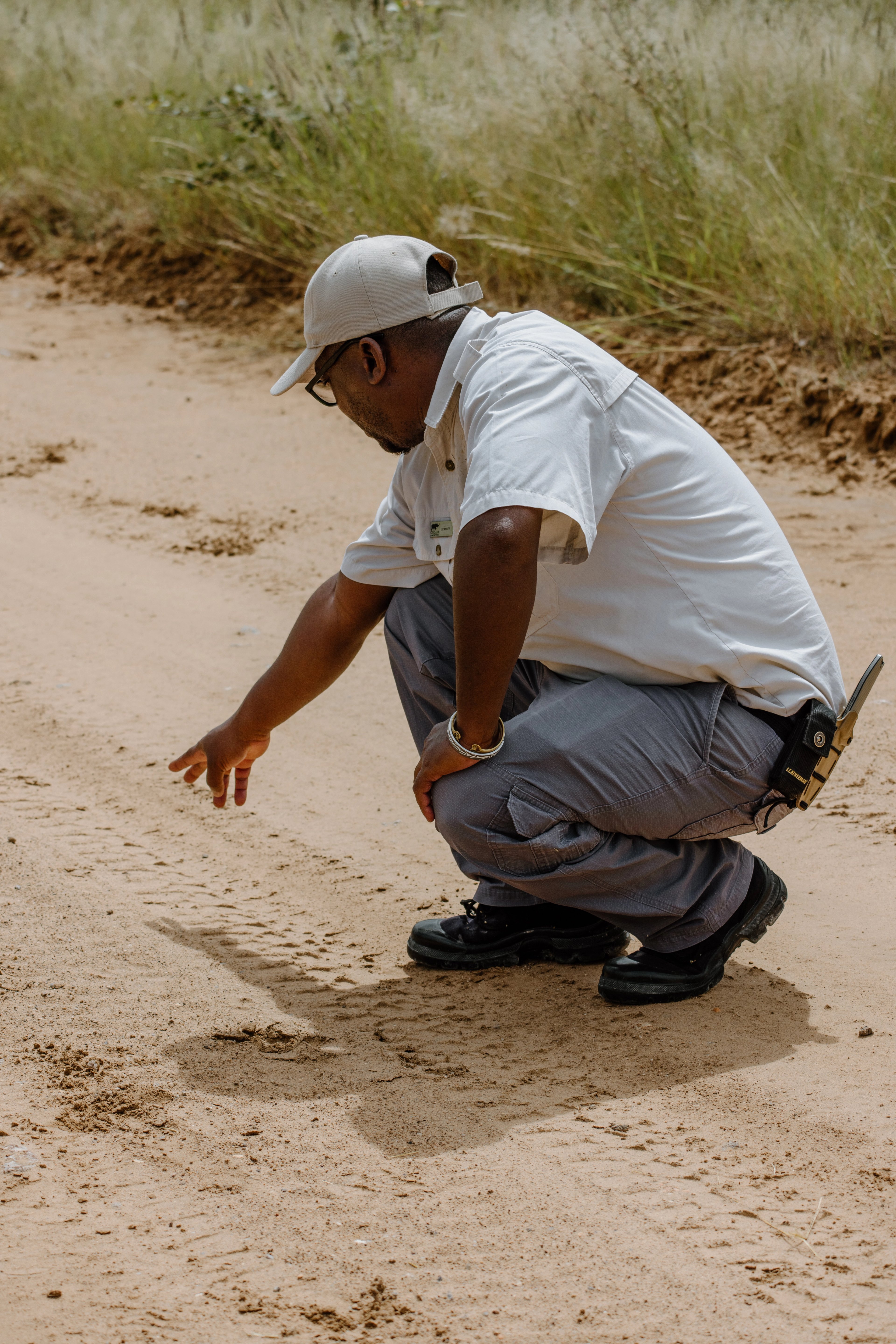 Stanley carefully studies the tracks, reading the stories the bush tells.
