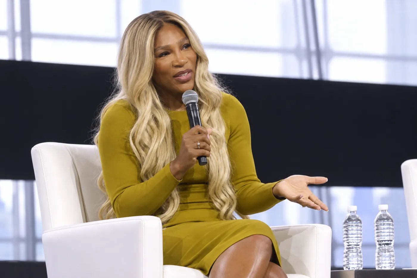 Serena speaking into a microphone